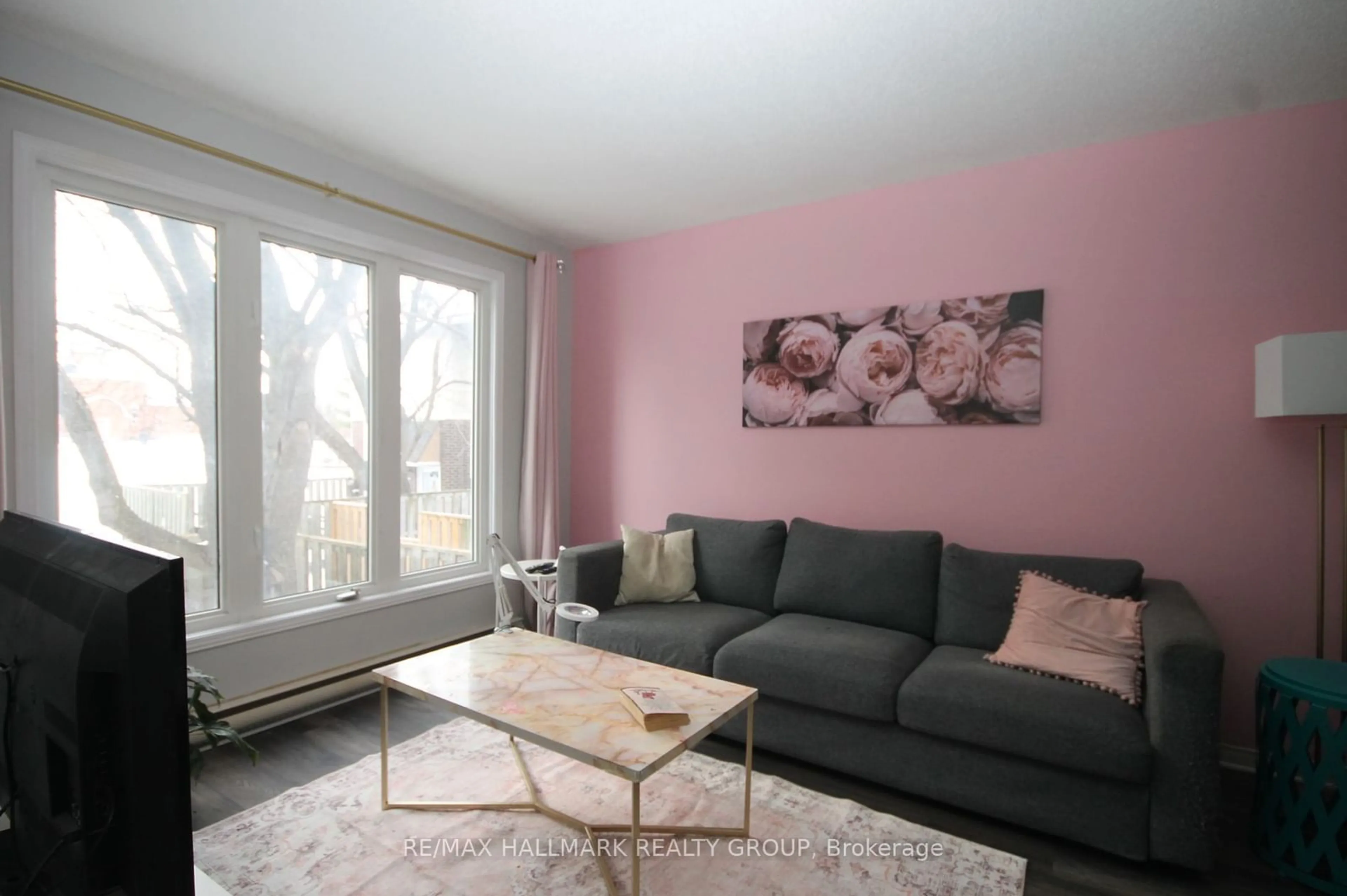 Living room with furniture, wood/laminate floor for 107 SALTER Cres, Kanata Ontario K2K 1Y7