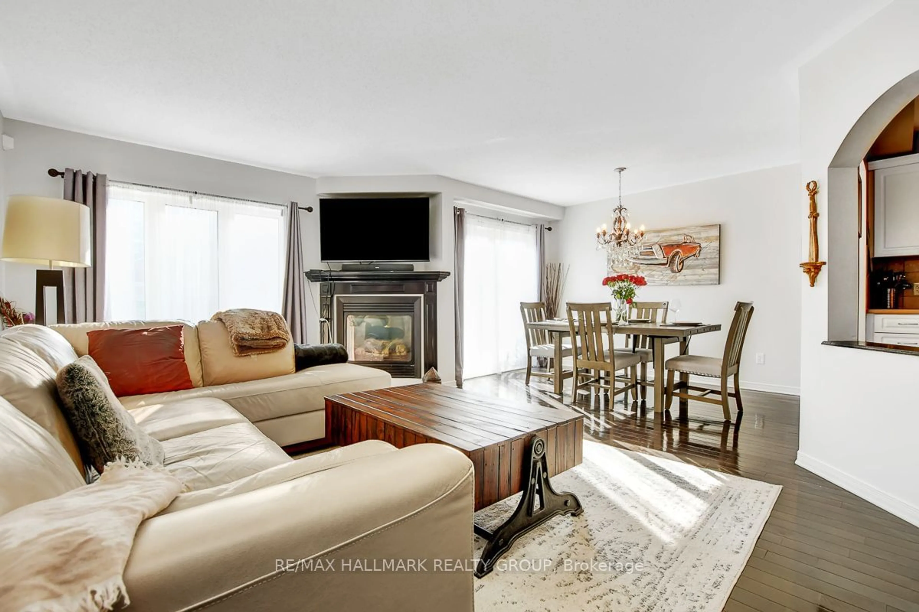 Living room with furniture, wood/laminate floor for 211 Sorento St, Barrhaven Ontario K2J 0B6