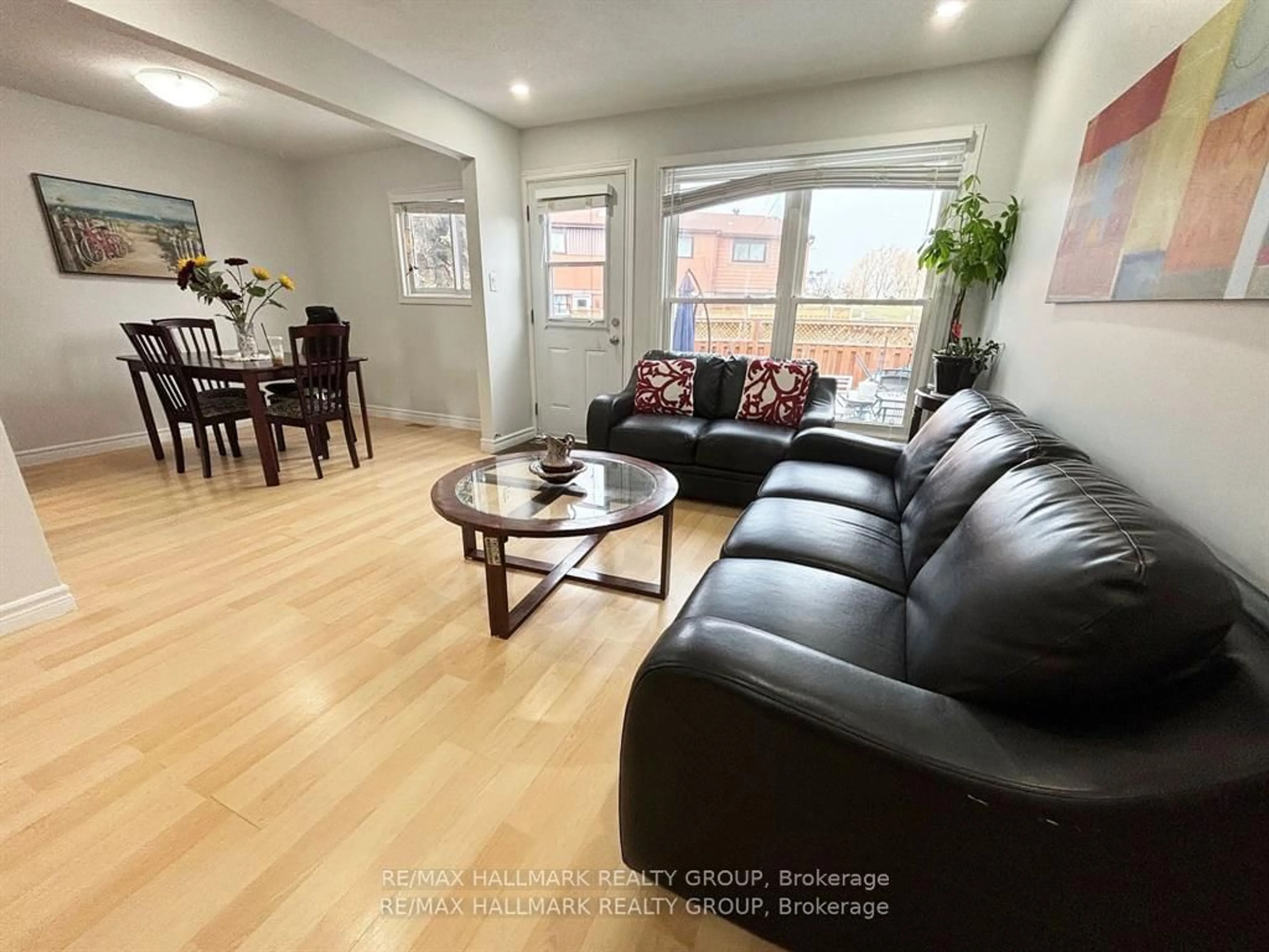 Living room with furniture, wood/laminate floor for 56D Foxfield Dr #29, Barrhaven Ontario K2J 1P7