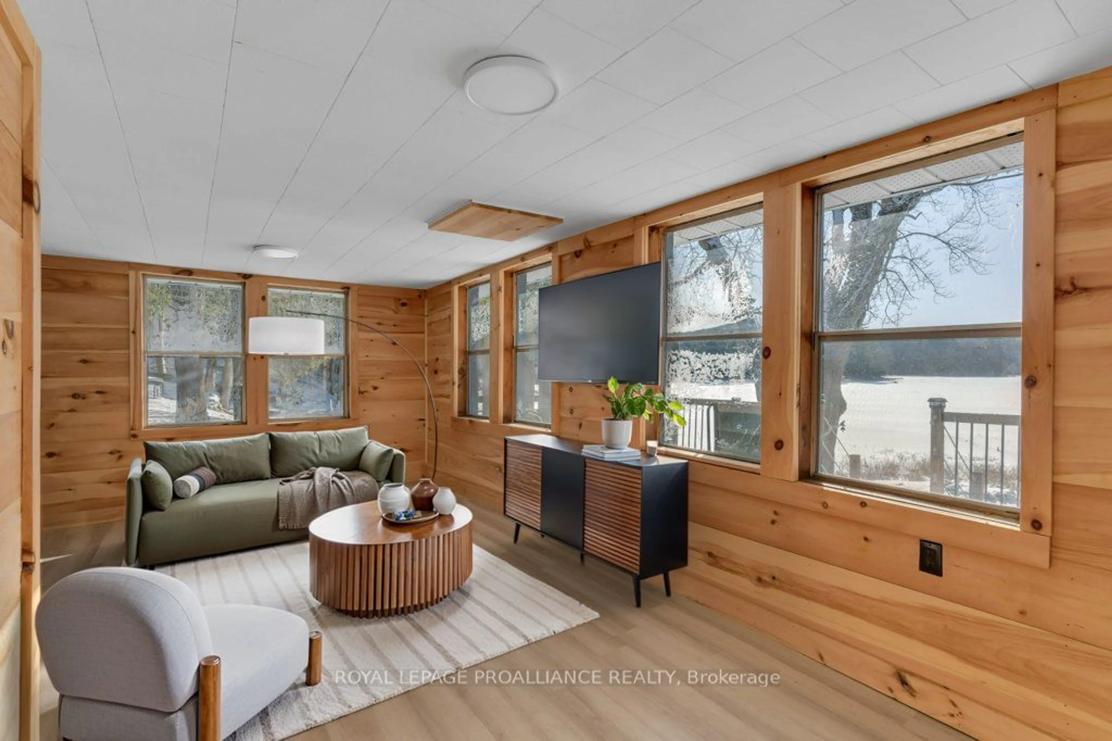 Living room with furniture, wood/laminate floor for 2077 Hambly Lane, South Frontenac Ontario K0H 1W0