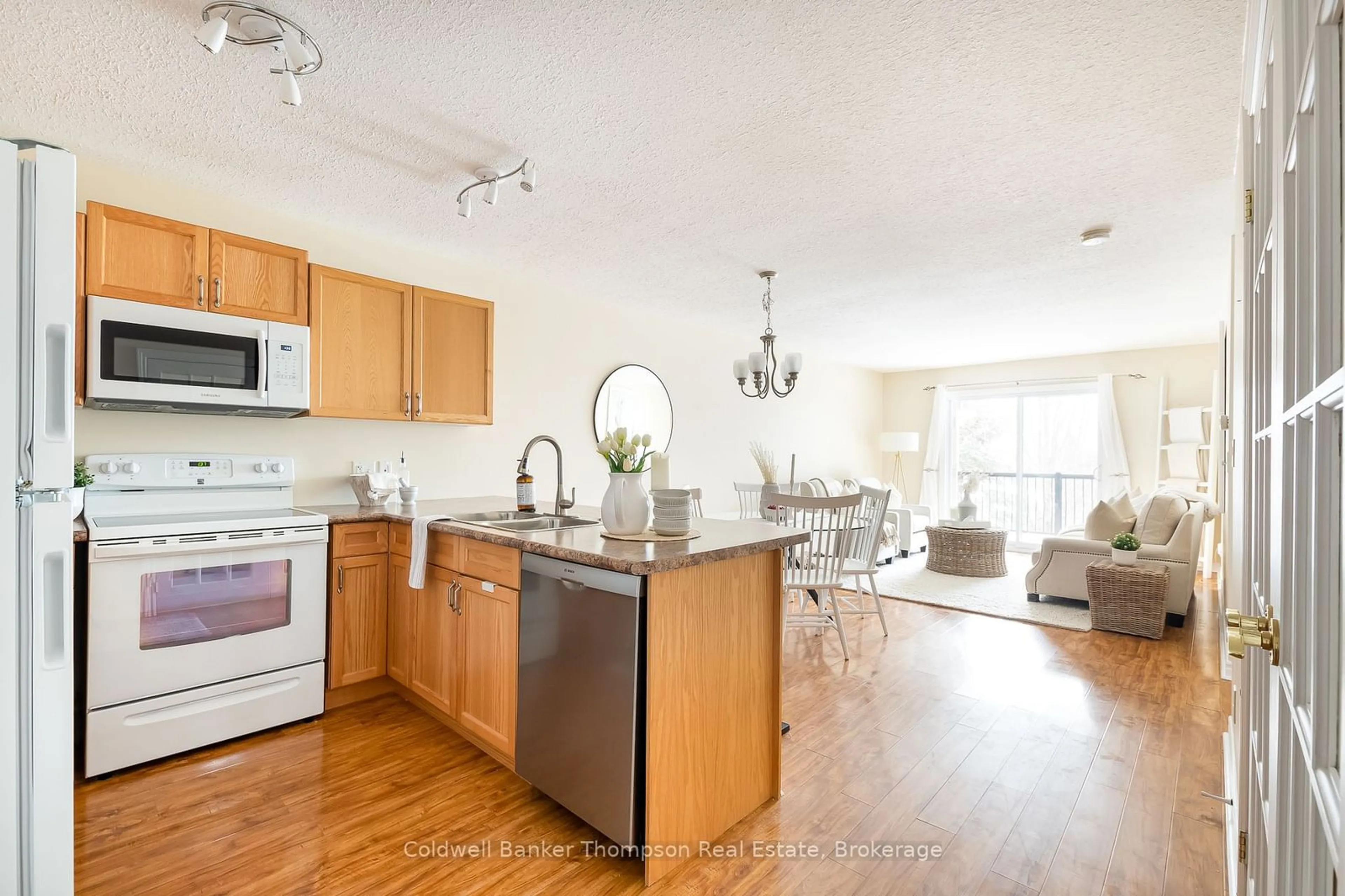 Open concept kitchen, wood/laminate floor for 4 Legacy Lane #203, Huntsville Ontario P1H 2R2