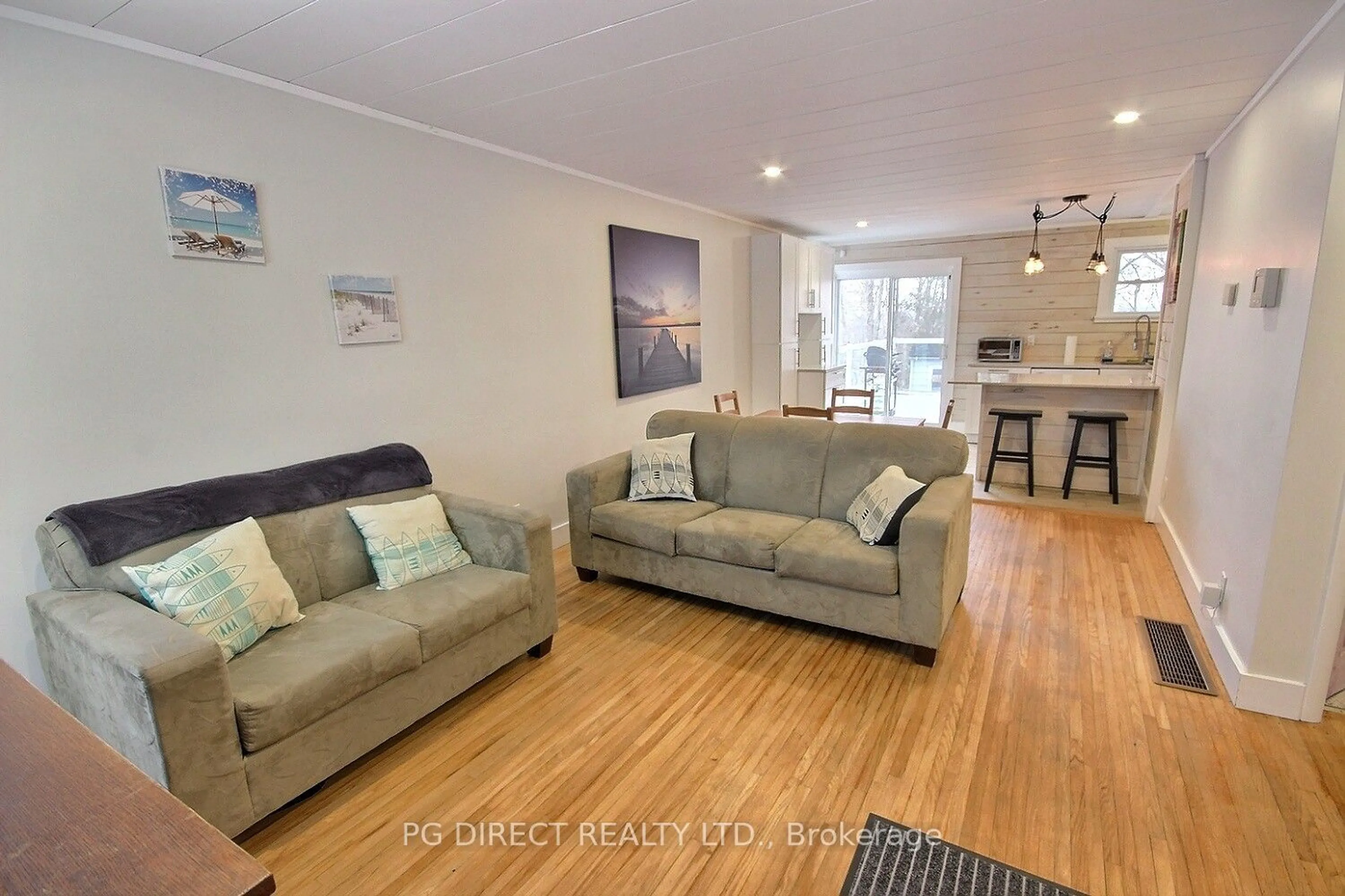 Living room with furniture, wood/laminate floor for 1310 County Rd 3, Prince Edward County Ontario K0K 1L0