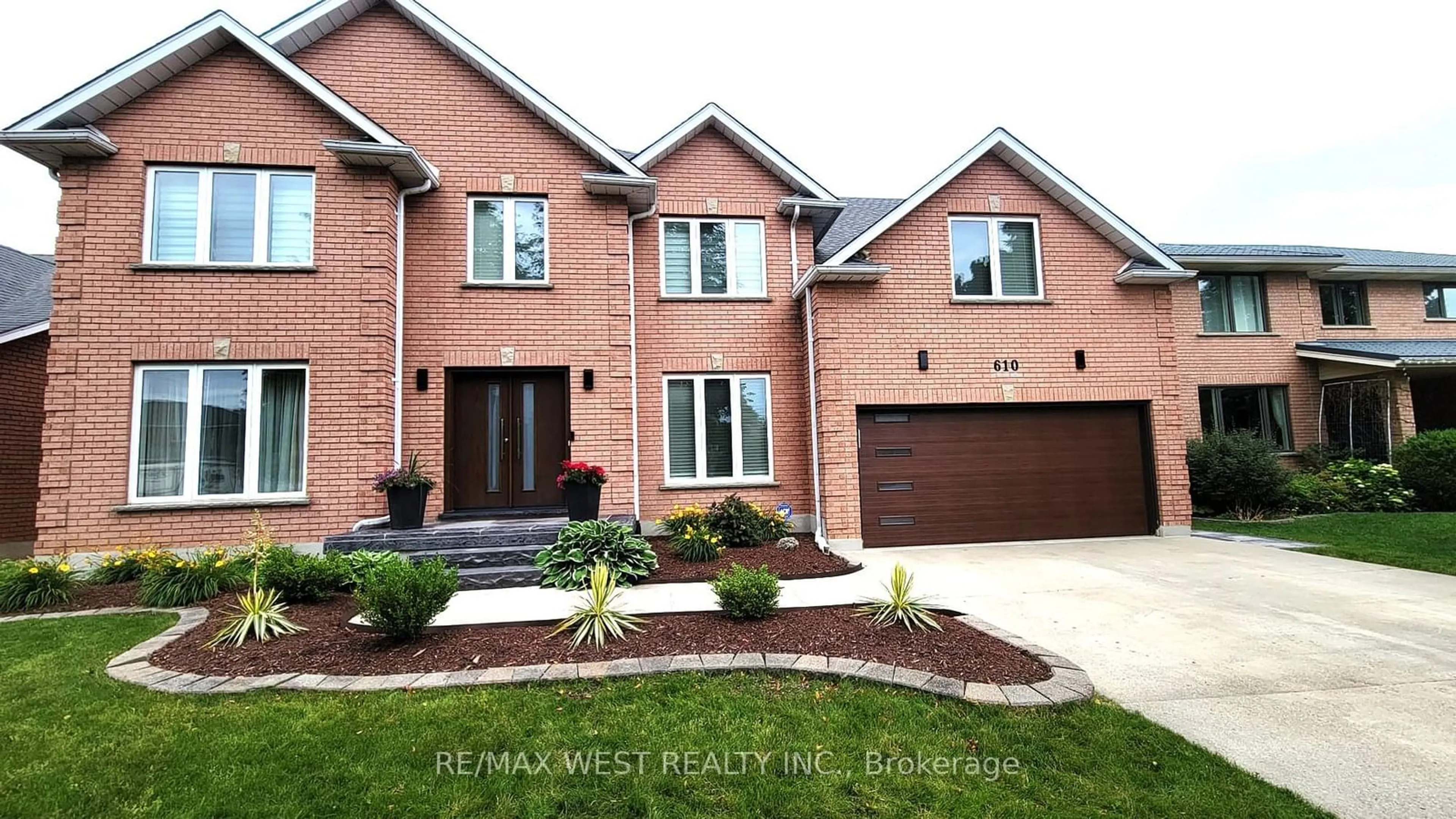 Home with brick exterior material, street for 610 Stonebury Cres, Waterloo Ontario N2K 3R1