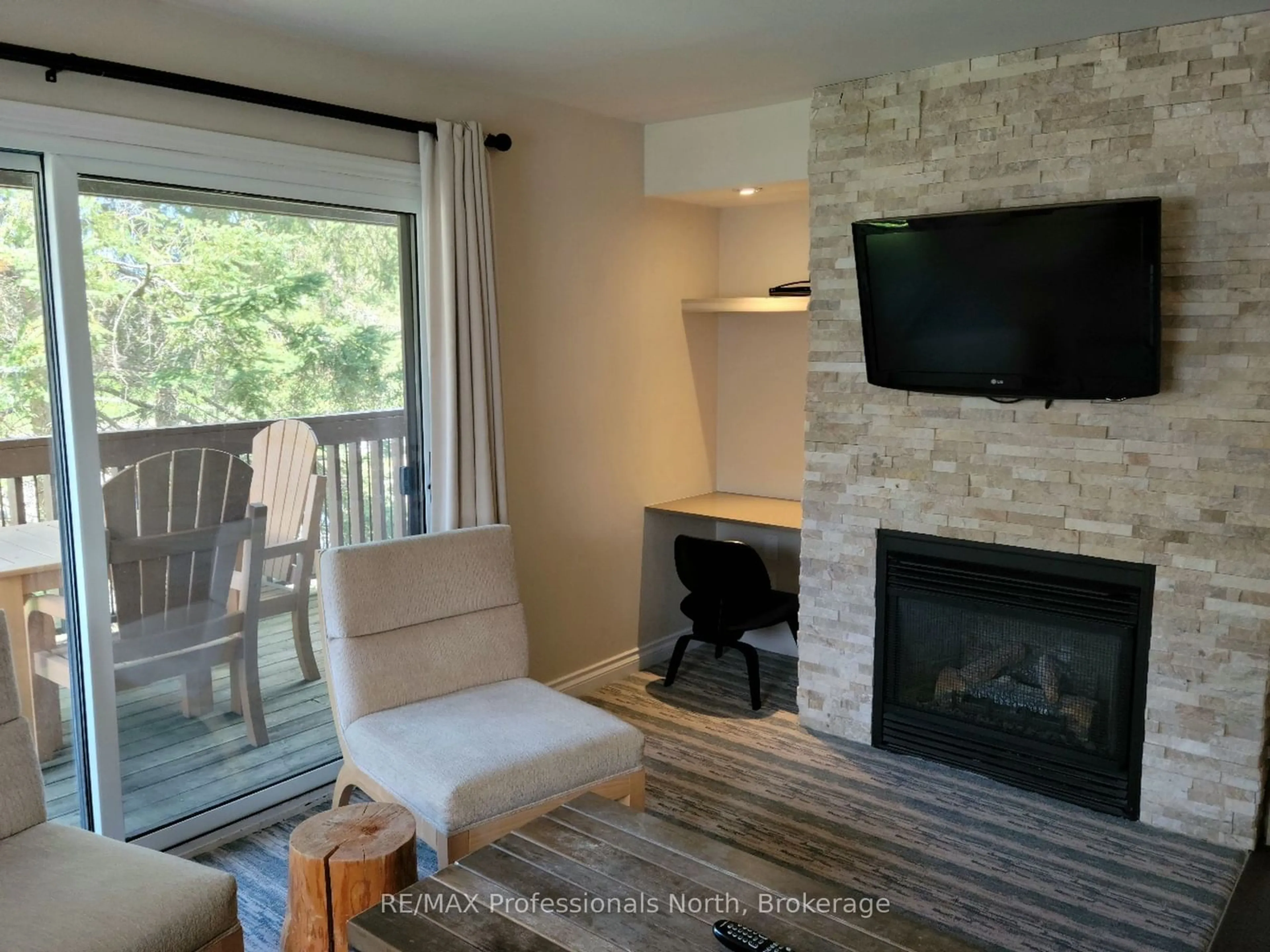 Living room with furniture, wood/laminate floor for 1235 Deerhurst Dr #54-207, Huntsville Ontario P1H 2E8