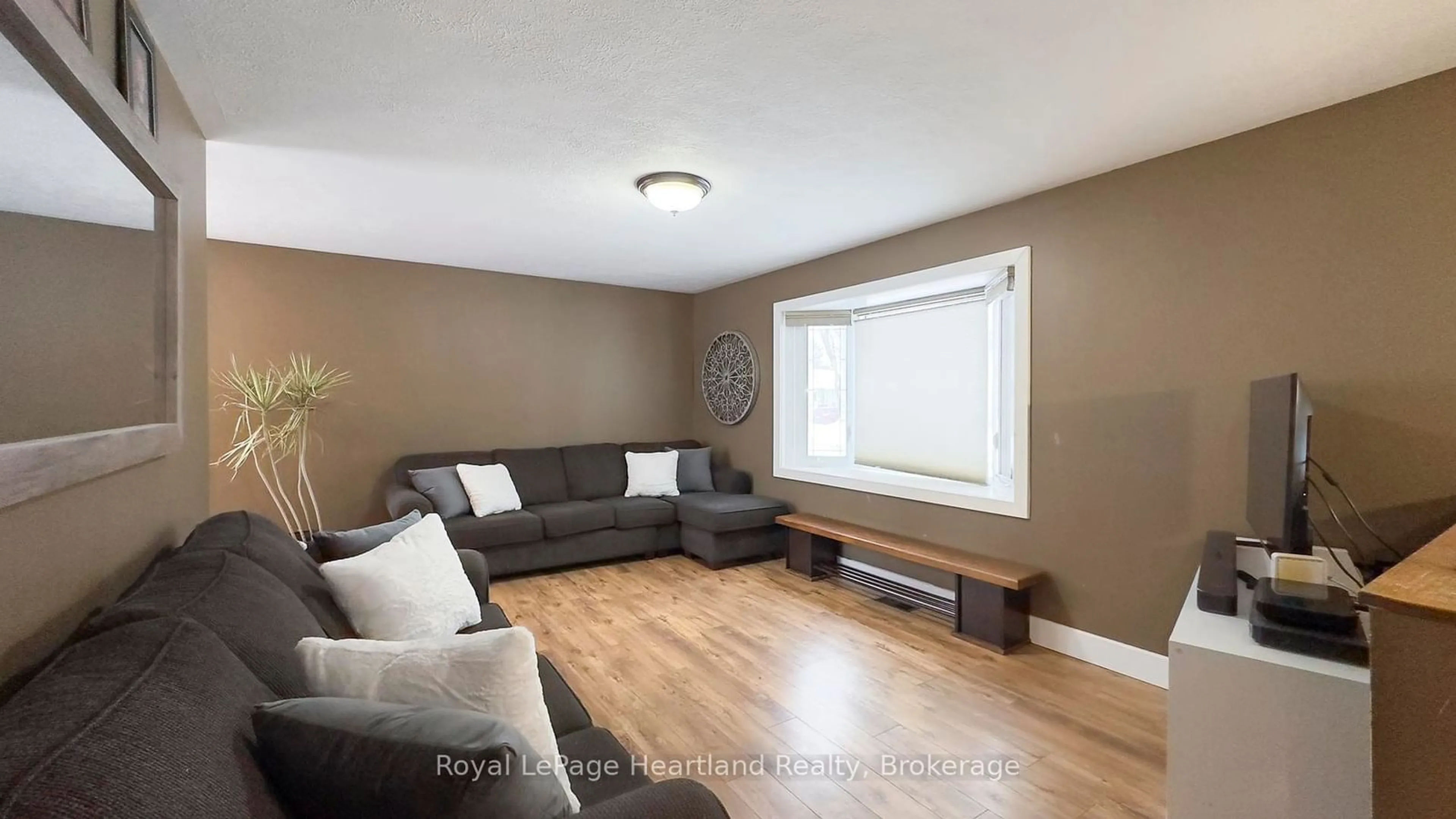 Living room with furniture, wood/laminate floor for 223 Bennett St, Goderich Ontario N7A 1A8