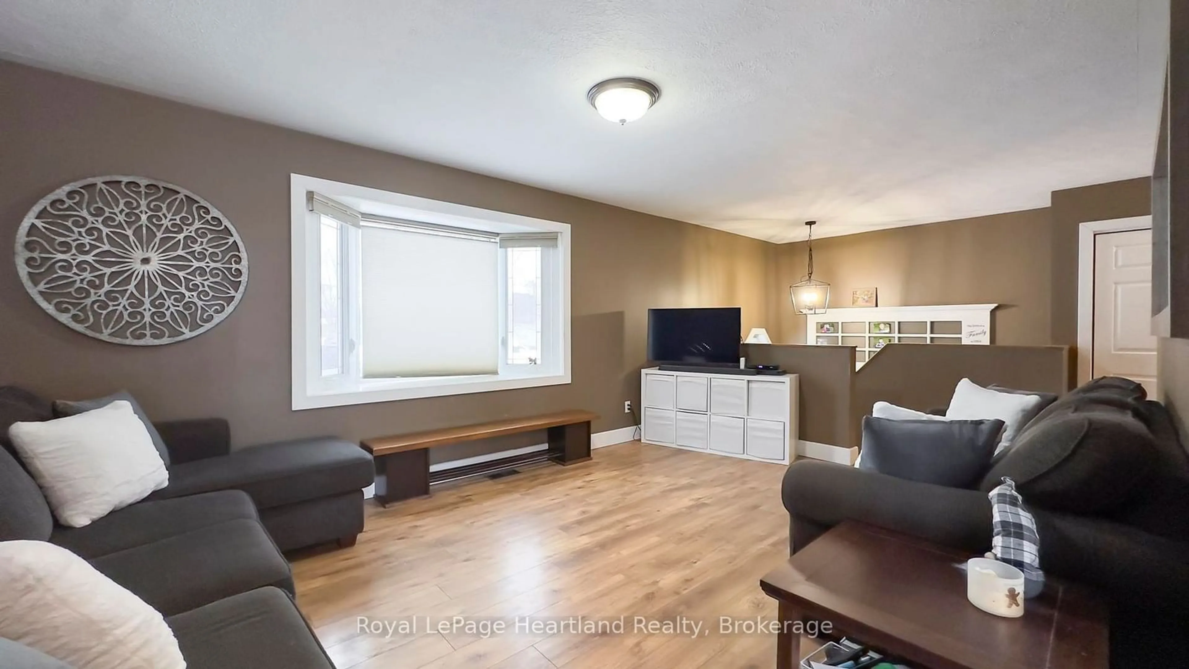 Living room with furniture, wood/laminate floor for 223 Bennett St, Goderich Ontario N7A 1A8