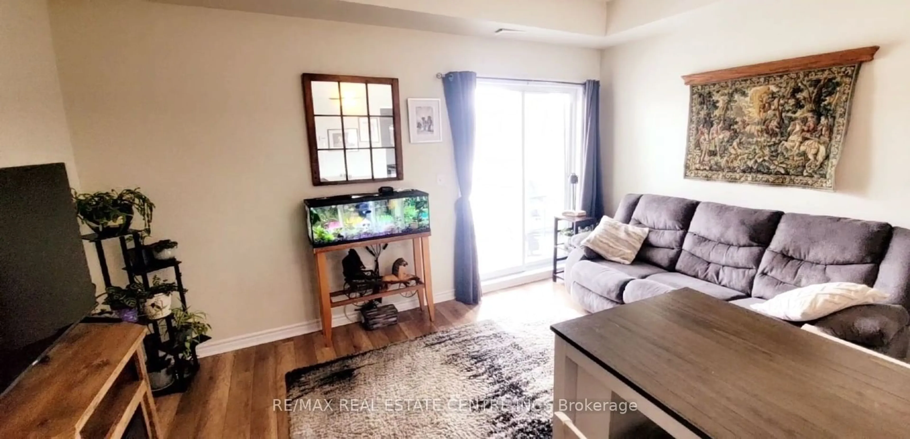 Living room with furniture, wood/laminate floor for 308 Watson Pkwy #118, Guelph Ontario N1E 0G7