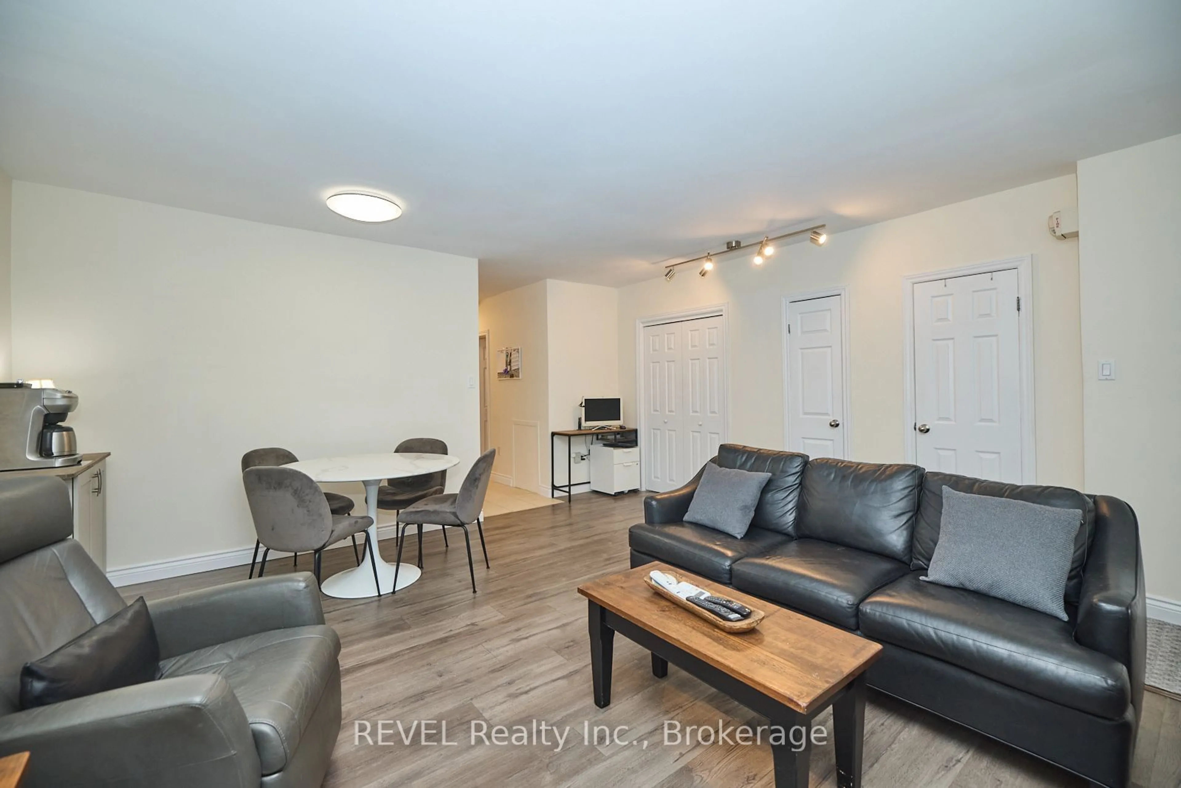 Living room with furniture, wood/laminate floor for 450 Carlton St #2, St. Catharines Ontario L2M 4X1