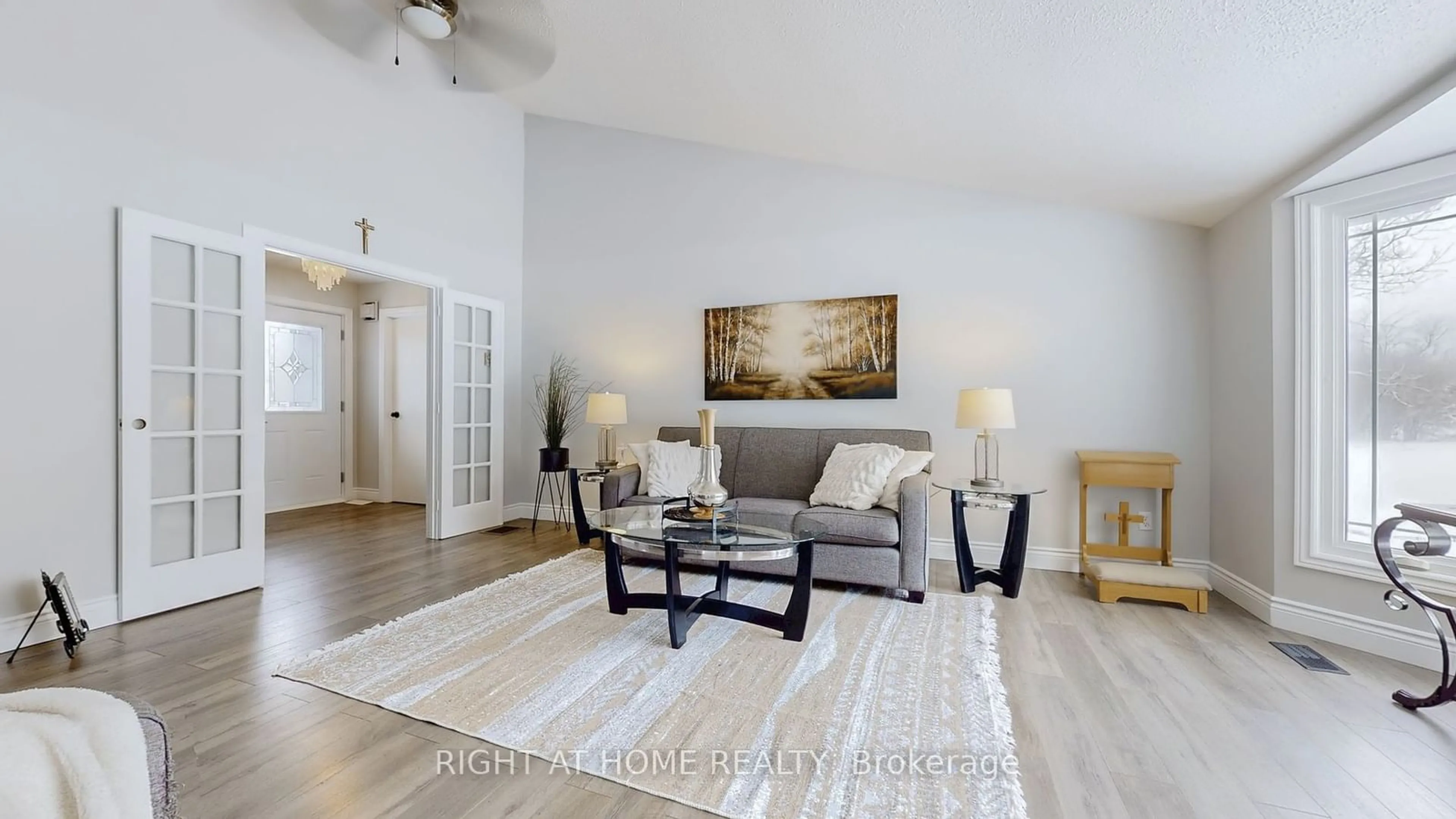 Living room with furniture, wood/laminate floor for 488 Ava Cres, Cavan Monaghan Ontario L0A 1G0