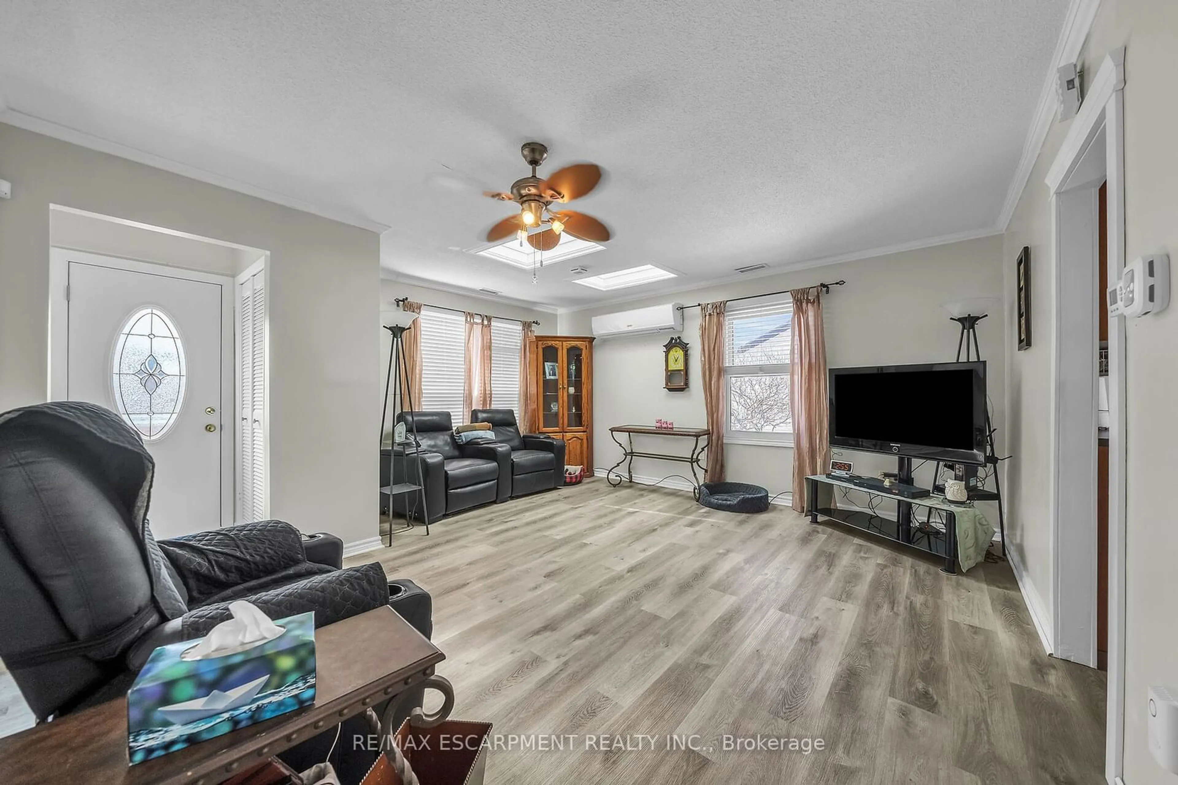 Living room with furniture, wood/laminate floor for 1793 Main St, Hamilton Ontario L8H 1E5