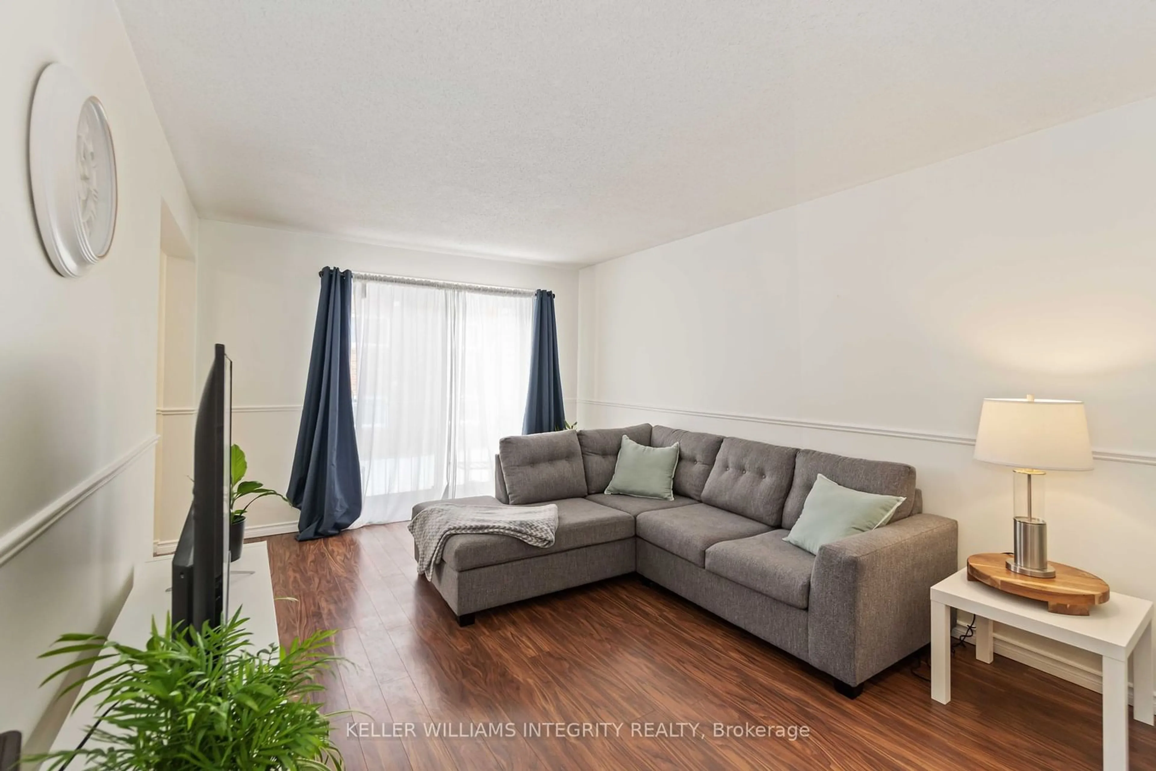 Living room with furniture, wood/laminate floor for 26 Pearl St #202, Smiths Falls Ontario K7A 5B5