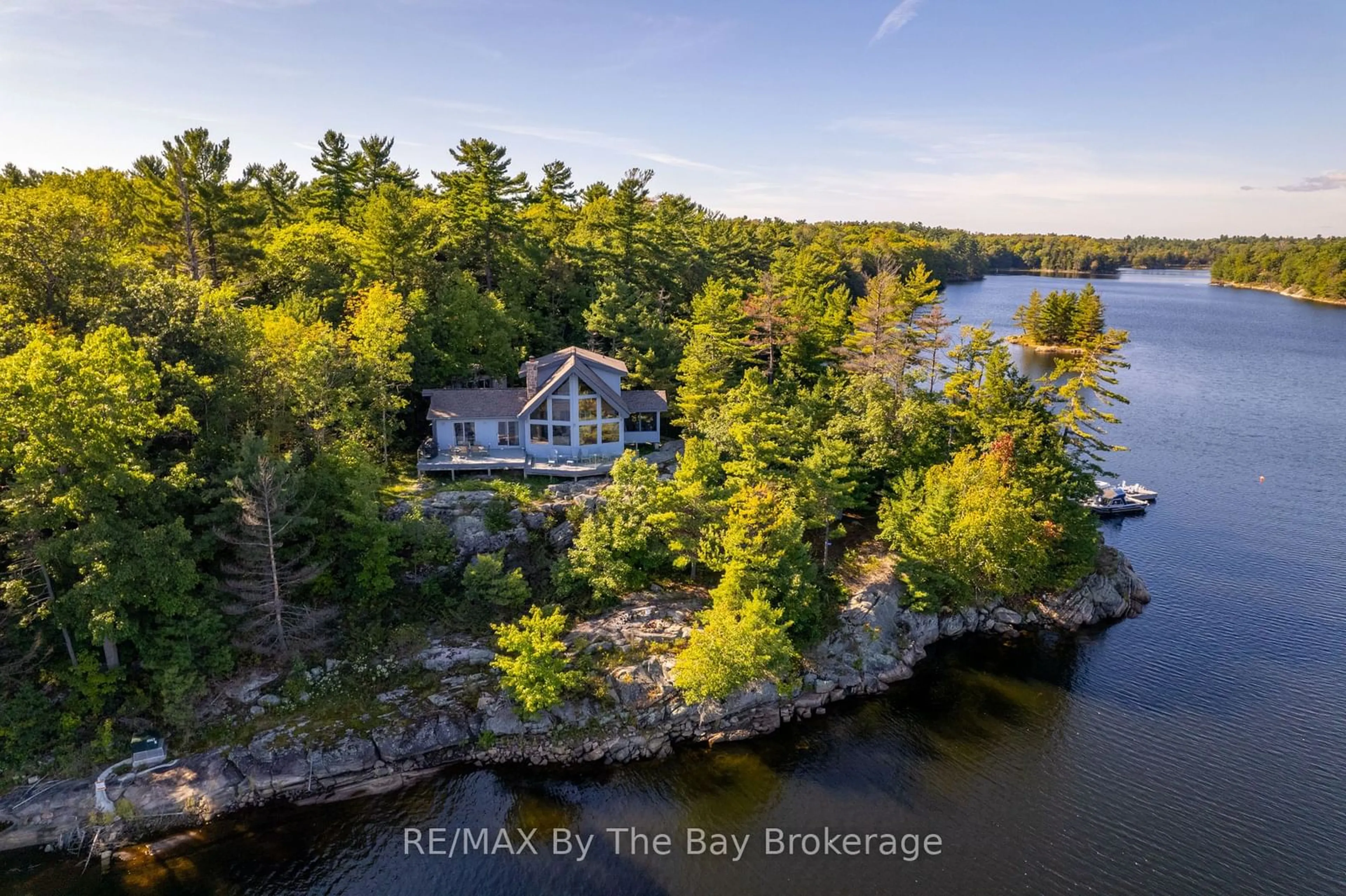 A pic from outside/outdoor area/front of a property/back of a property/a pic from drone, water/lake/river/ocean view for 23212 Georgian Bay Shr, Georgian Bay Ontario P0E 1E0