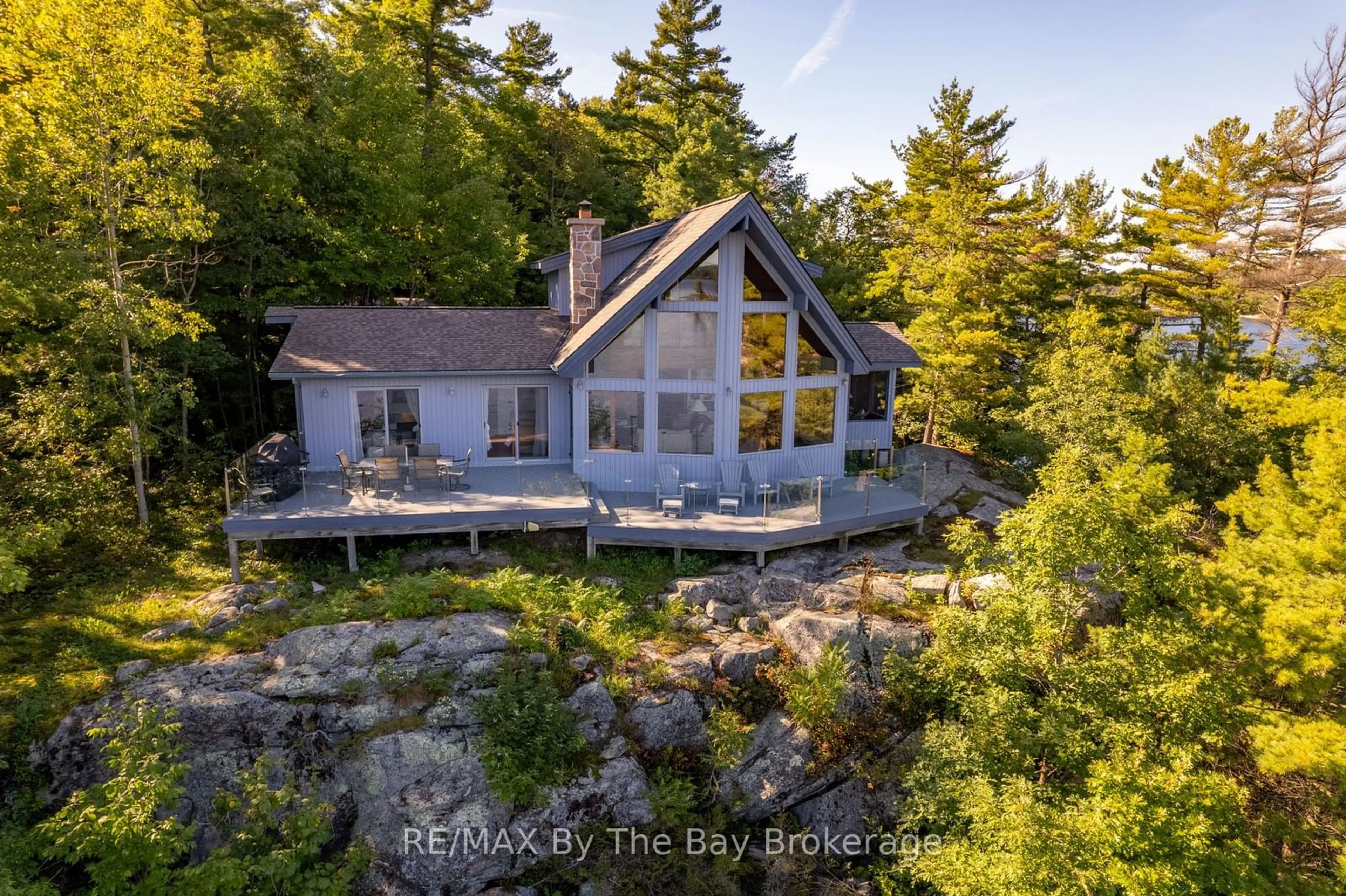 A pic from outside/outdoor area/front of a property/back of a property/a pic from drone, water/lake/river/ocean view for 23212 Georgian Bay Shr, Georgian Bay Ontario P0E 1E0