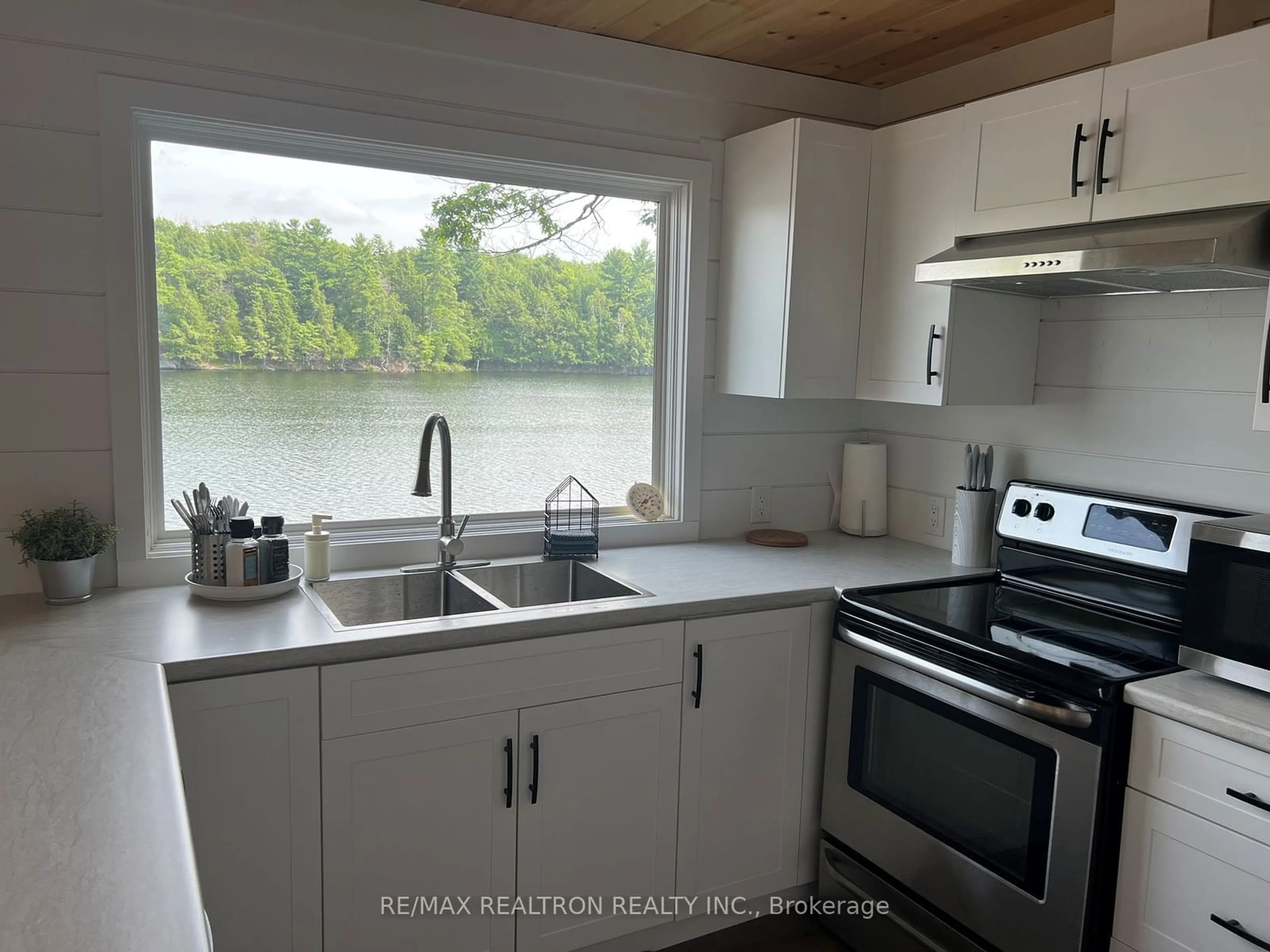 Open concept kitchen, wood/laminate floor for 203 Healey Lake, The Archipelago Ontario P0C 1H0