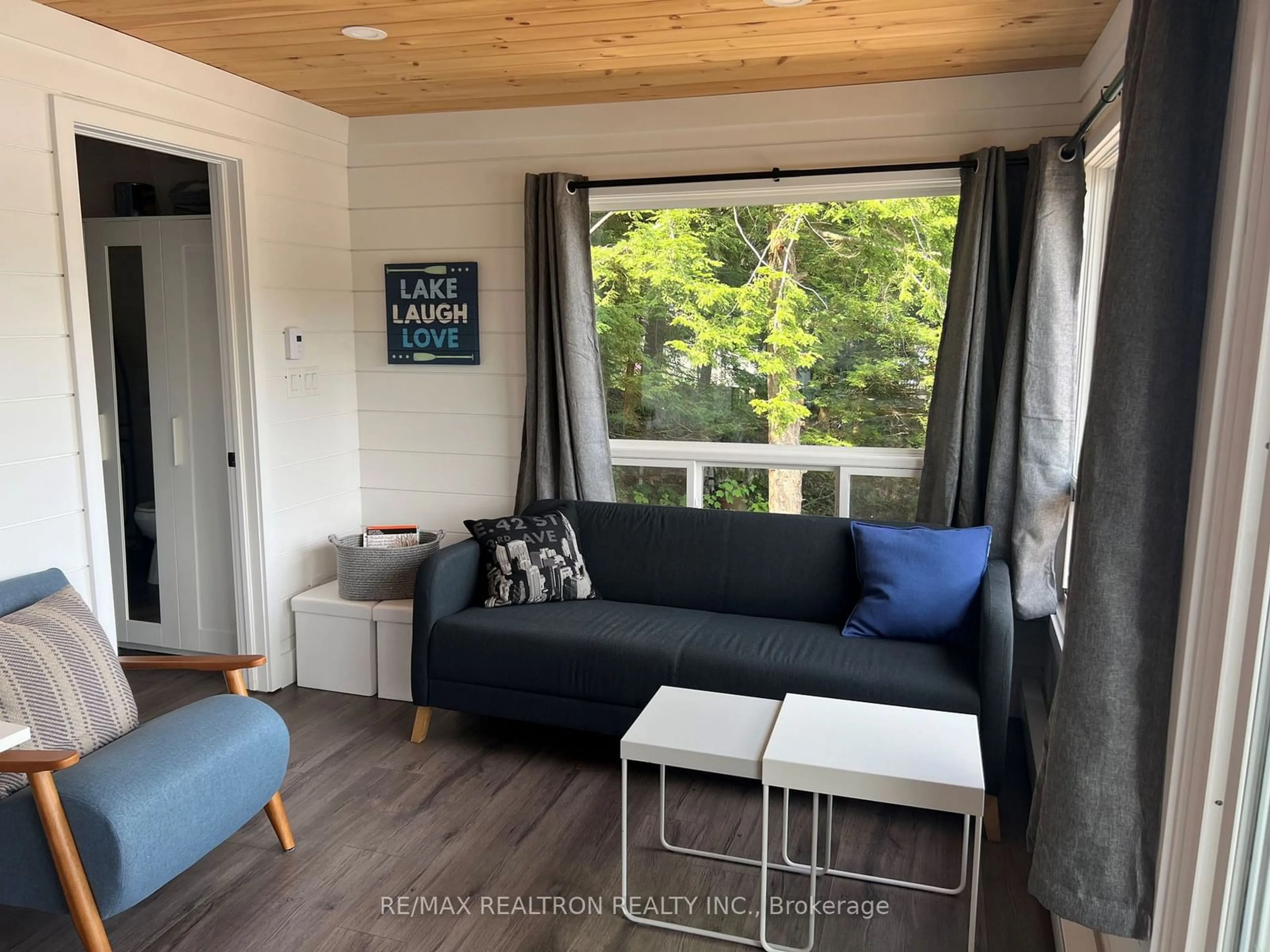 Living room with furniture, wood/laminate floor for 203 Healey Lake, The Archipelago Ontario P0C 1H0