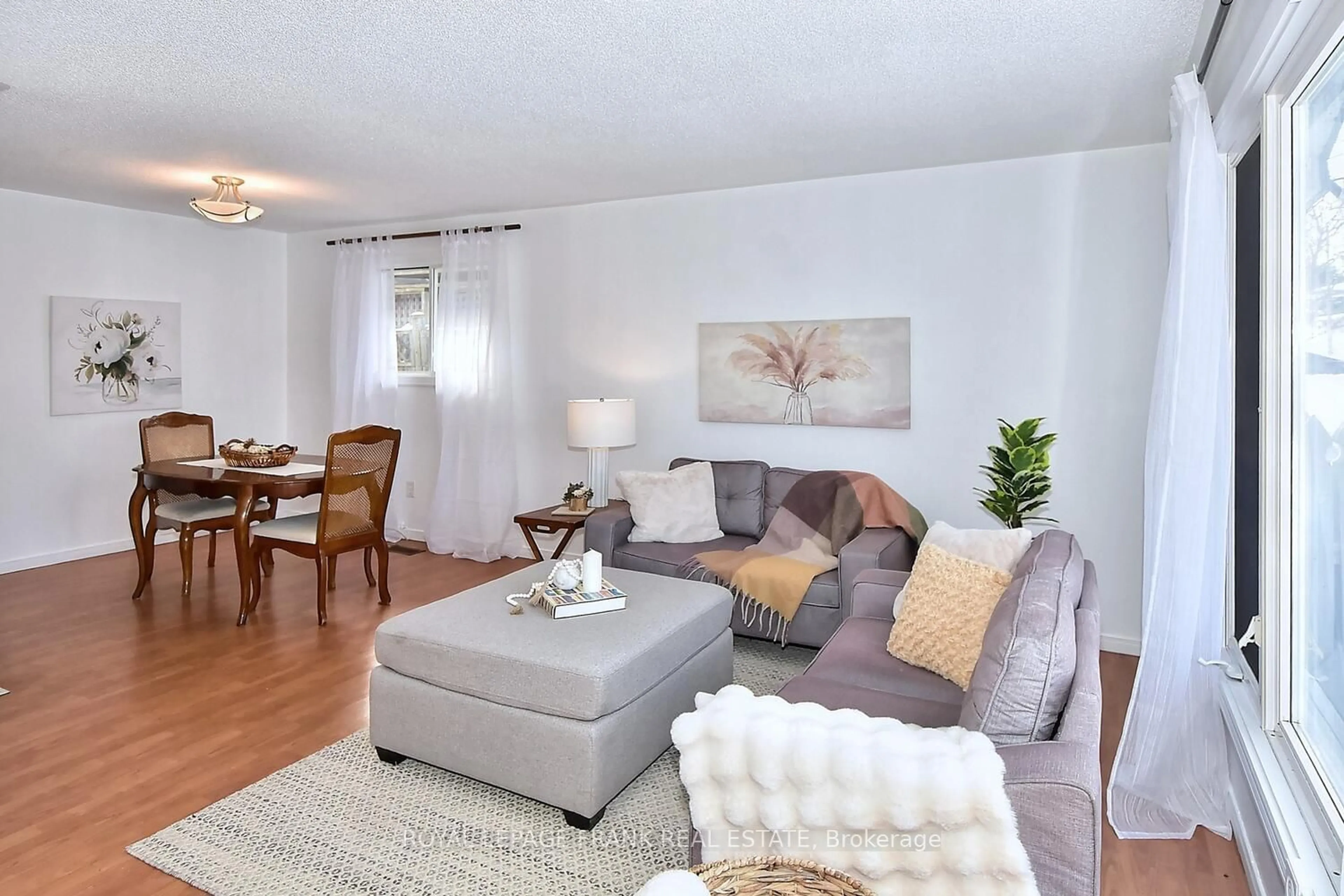 Living room with furniture, wood/laminate floor for 2238 Springwood Rd, Peterborough Ontario K9K 1S2