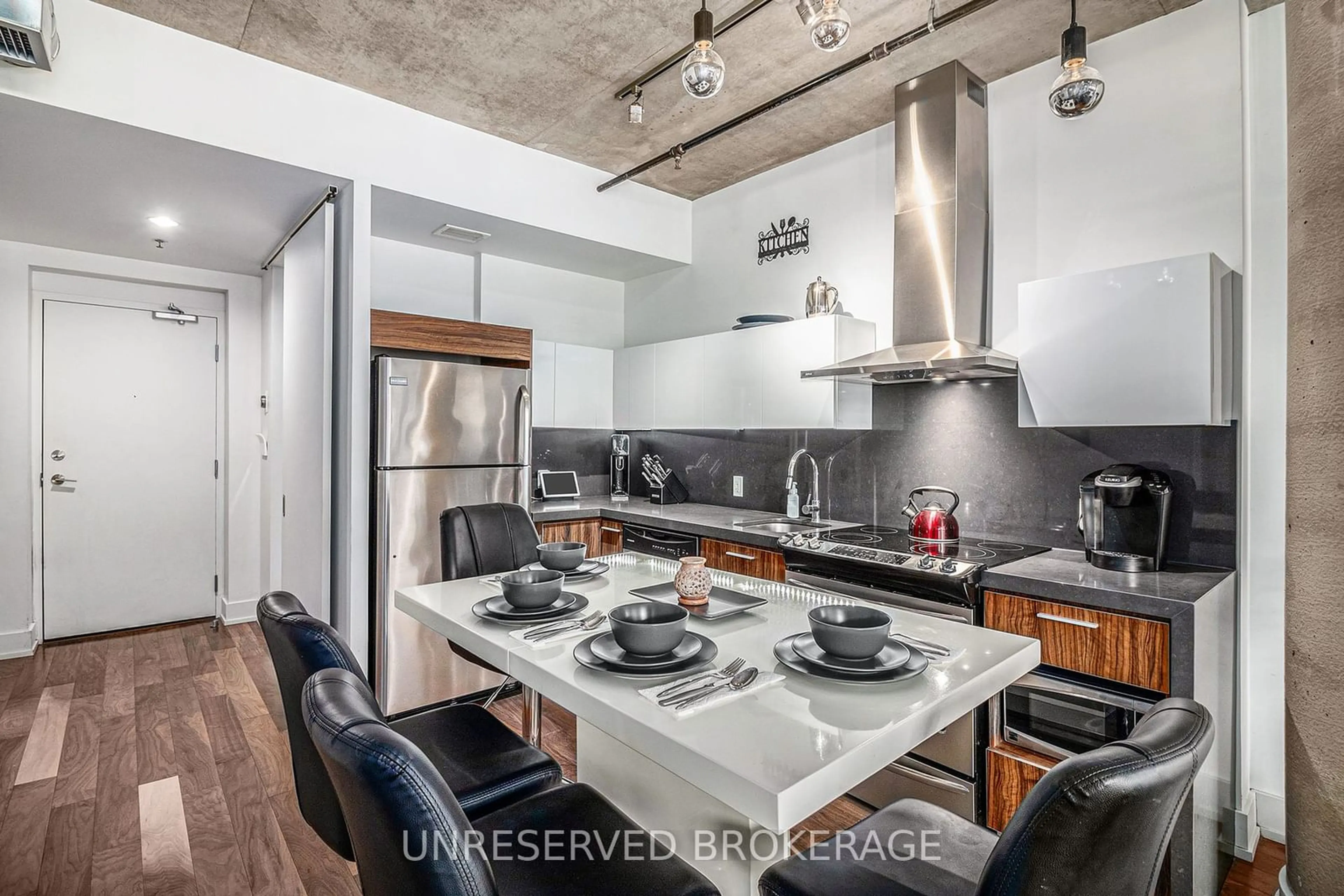 Open concept kitchen, cement floor for 360 McLeod St #207, Ottawa Centre Ontario K2P 1A9