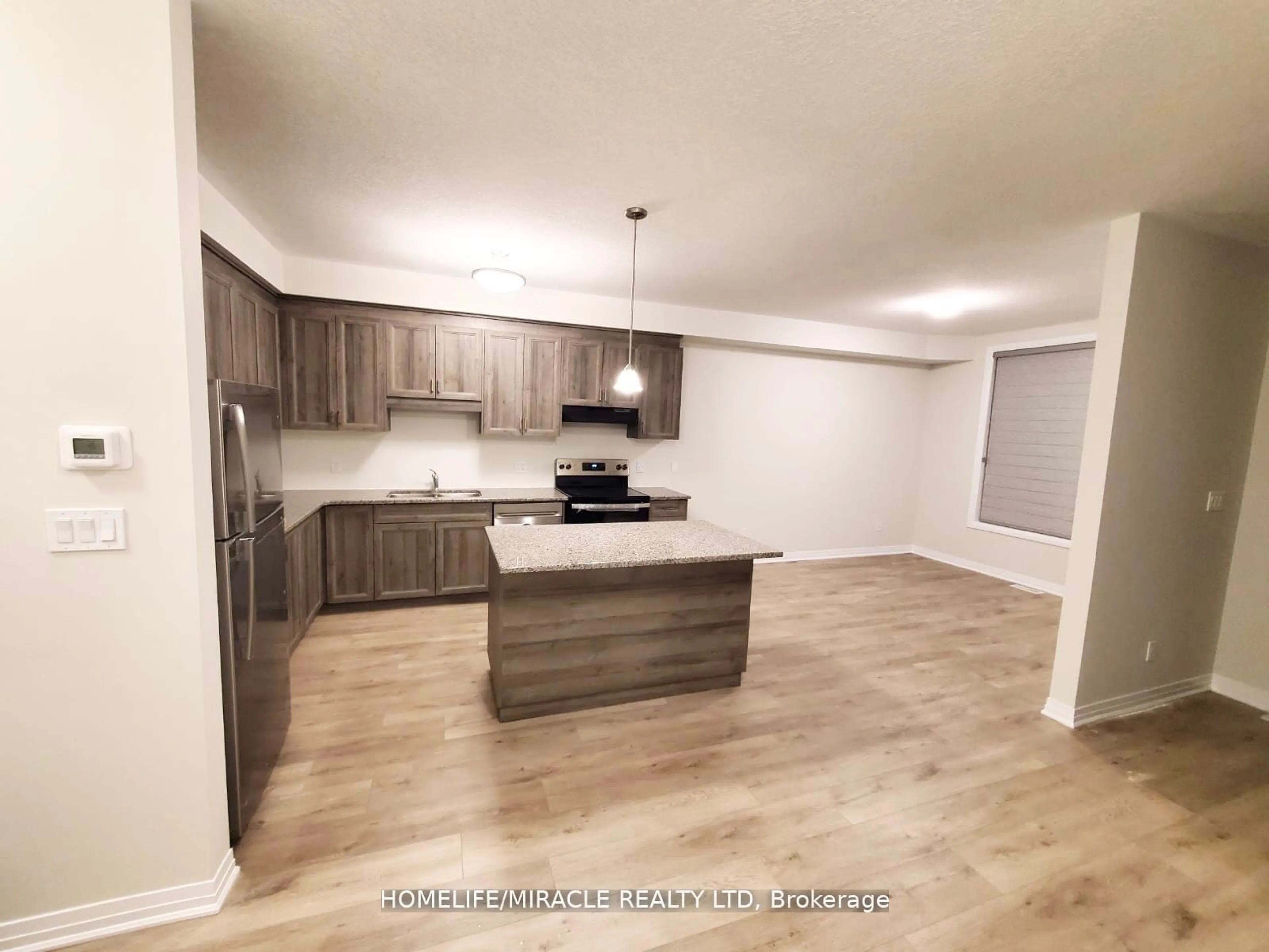 Open concept kitchen, wood/laminate floor for 25 Isherwood Ave #132, Cambridge Ontario N1R 0E2