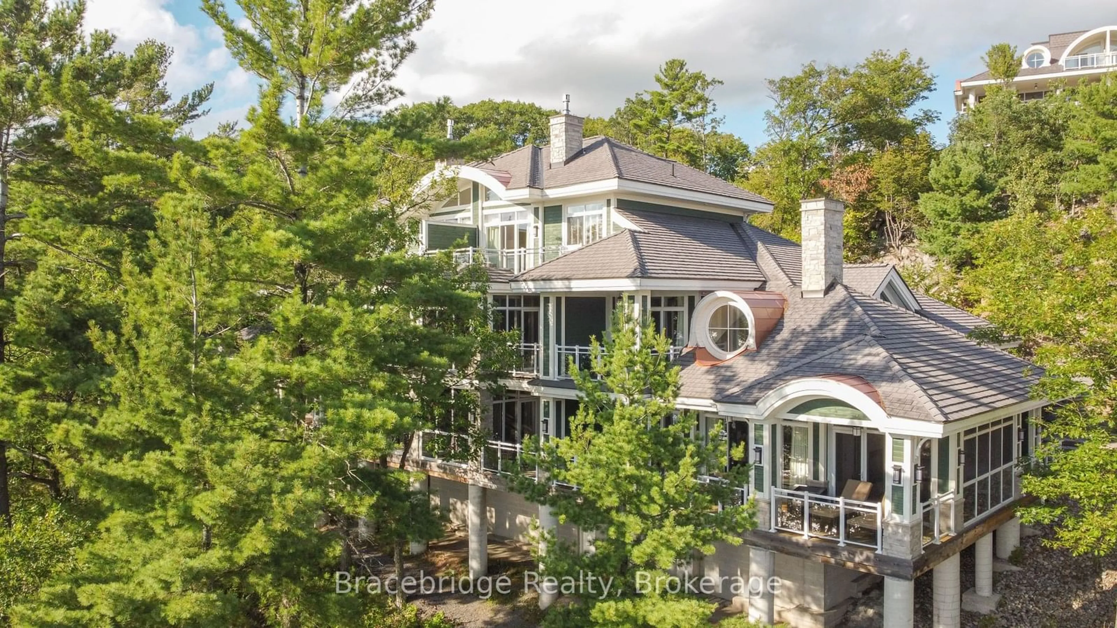 A pic from outside/outdoor area/front of a property/back of a property/a pic from drone, water/lake/river/ocean view for 1869 MUSKOKA ROAD 118 High #A104-C1, Muskoka Lakes Ontario P1L 1W8