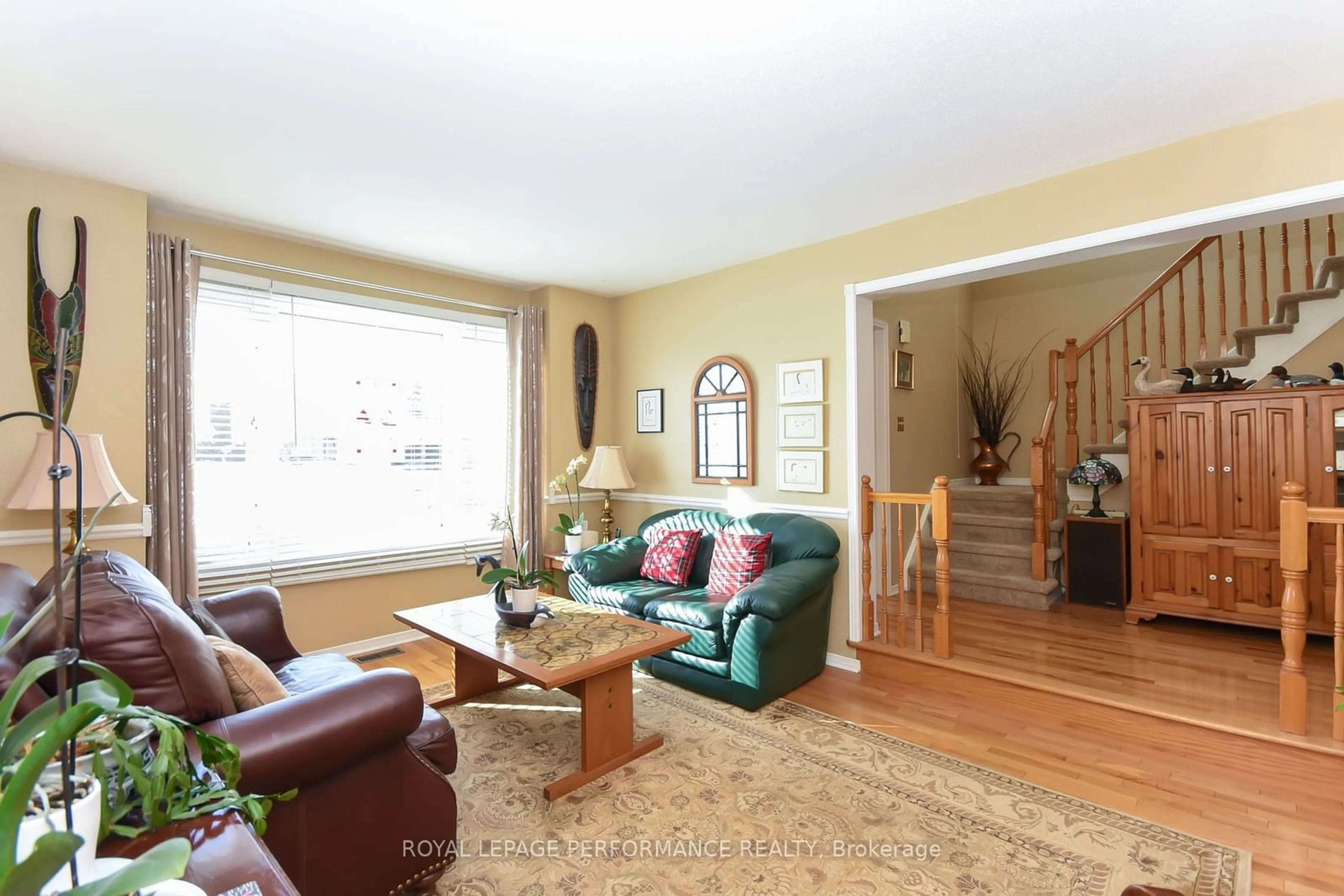 Living room with furniture, wood/laminate floor for 2826 Mozart Crt, Blossom Park - Airport and Area Ontario K1T 2P7