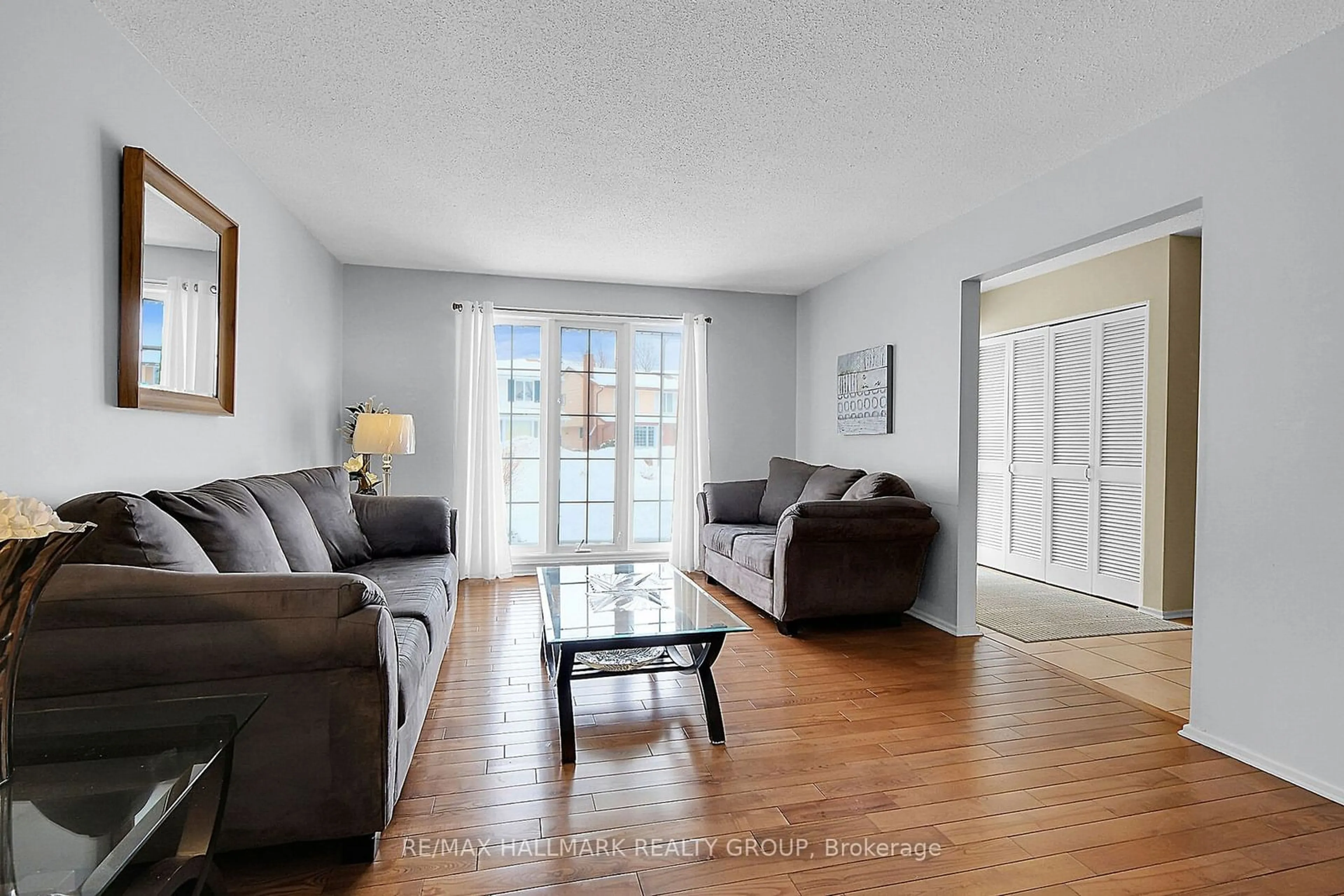 Living room with furniture, wood/laminate floor for 3318 Southgate Rd, Hunt Club - South Keys and Area Ontario K1V 8X3