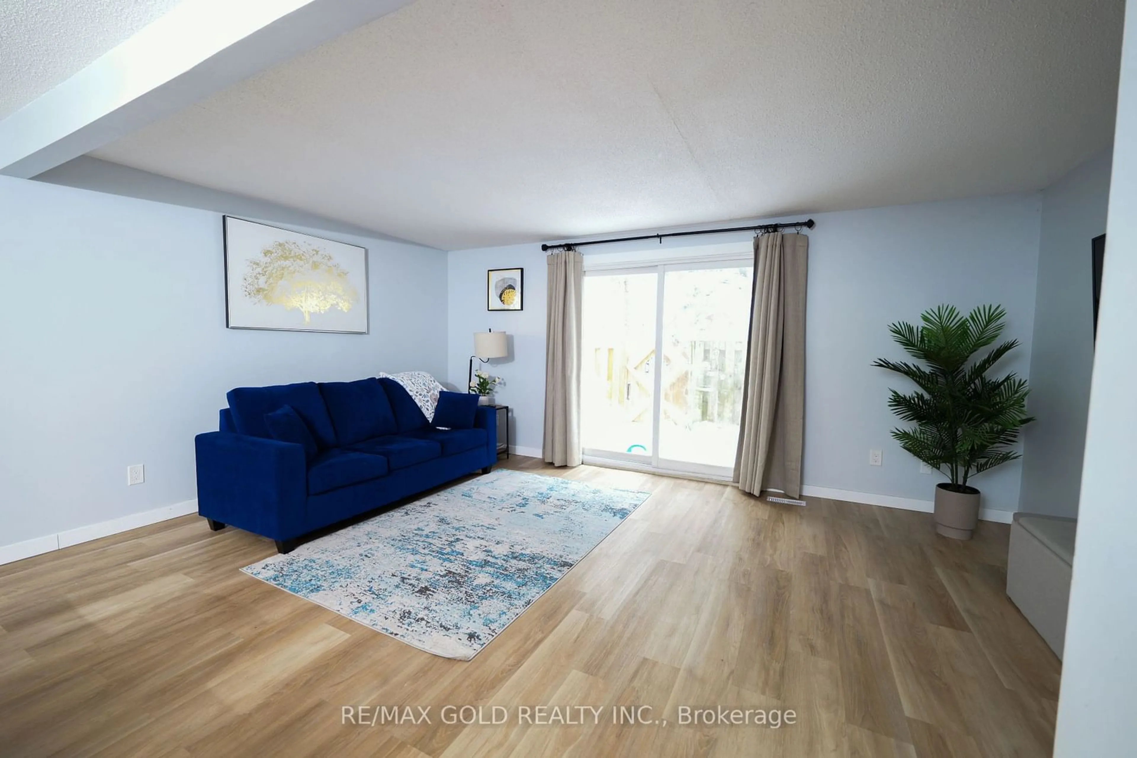 Living room with furniture, wood/laminate floor for 539 Willow Rd #64, Guelph Ontario N1H 7G3