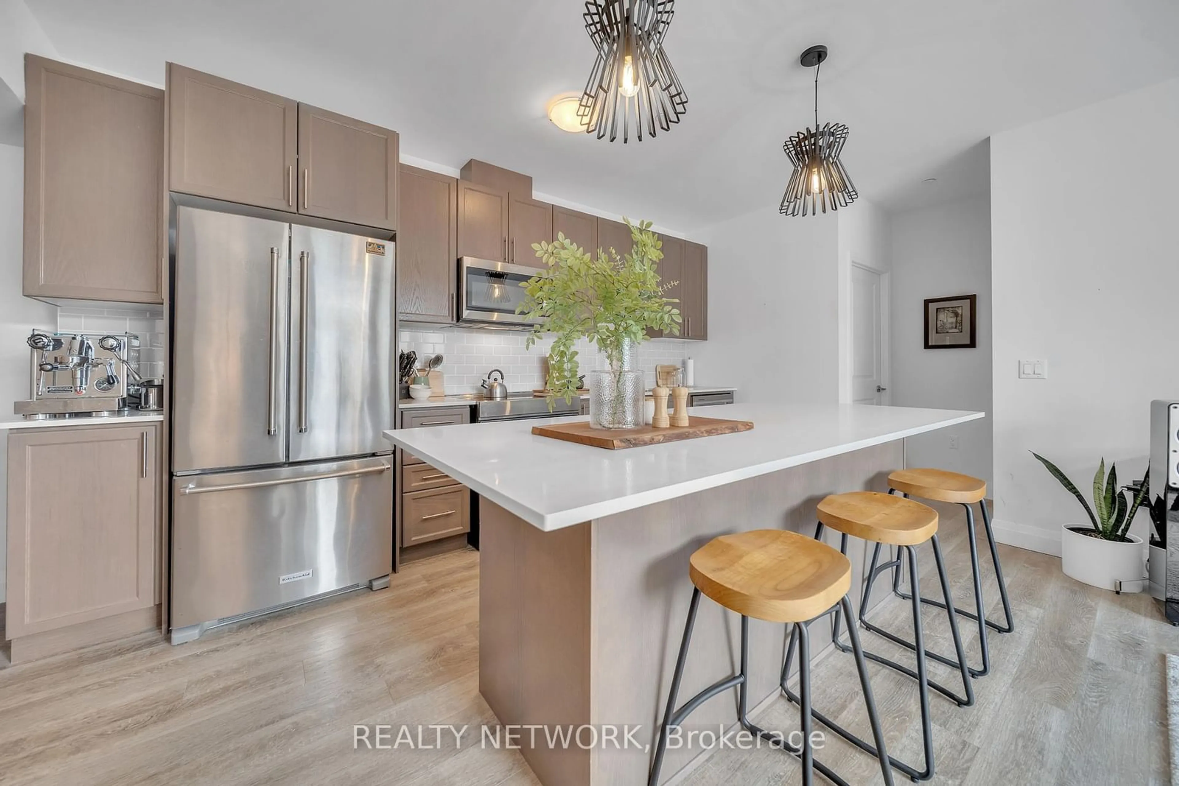 Open concept kitchen, wood/laminate floor for 1 Redfern Ave #410, Hamilton Ontario L9C 0E6