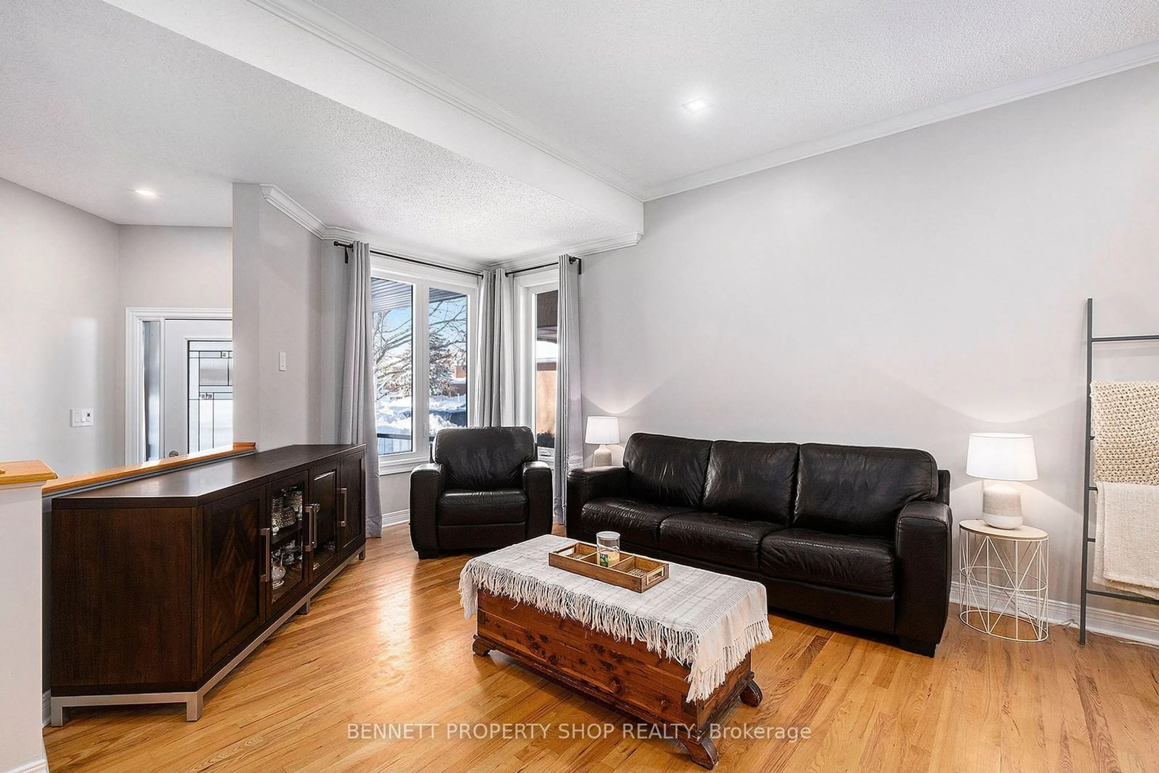 Living room with furniture, wood/laminate floor for 22 Tamarack Pl, Barrhaven Ontario K2J 4R4