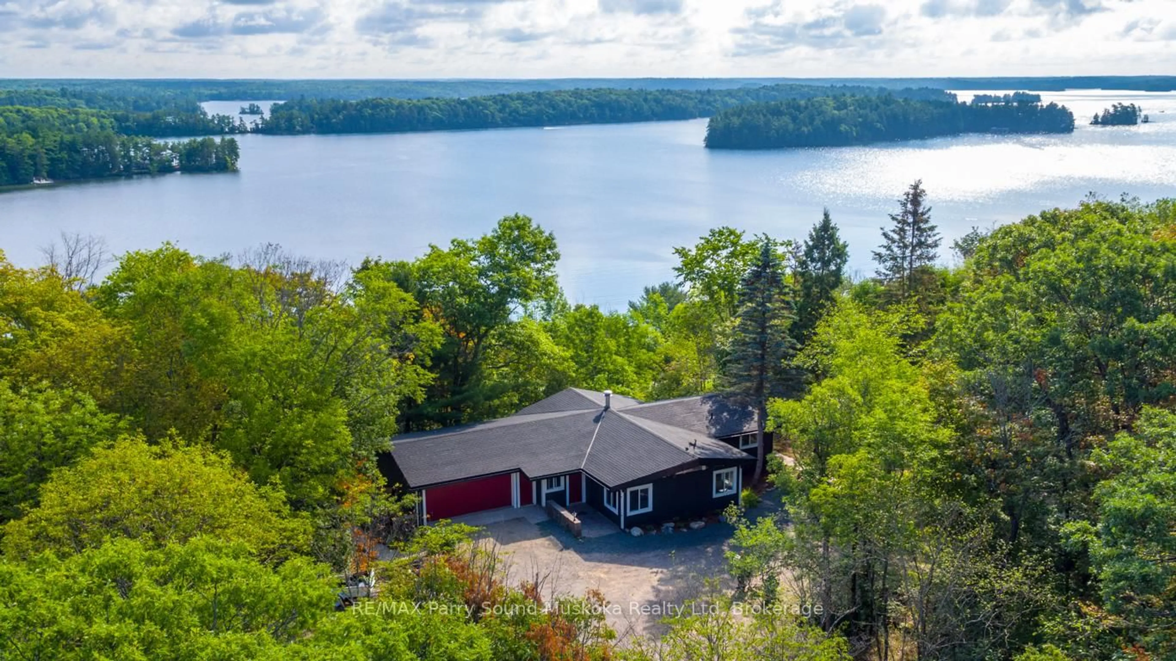 A pic from outside/outdoor area/front of a property/back of a property/a pic from drone, water/lake/river/ocean view for 143A Highway 612, Seguin Ontario P0C 1H0