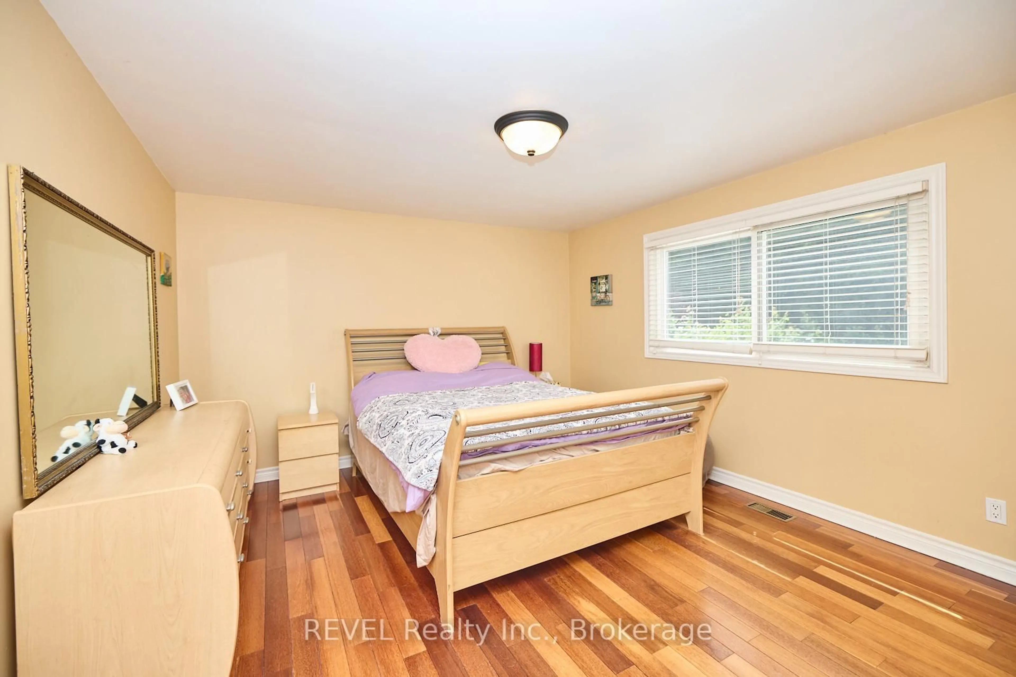 Bedroom with bed, wood/laminate floor for 6421 Dorchester Rd, Niagara Falls Ontario L2G 5T6