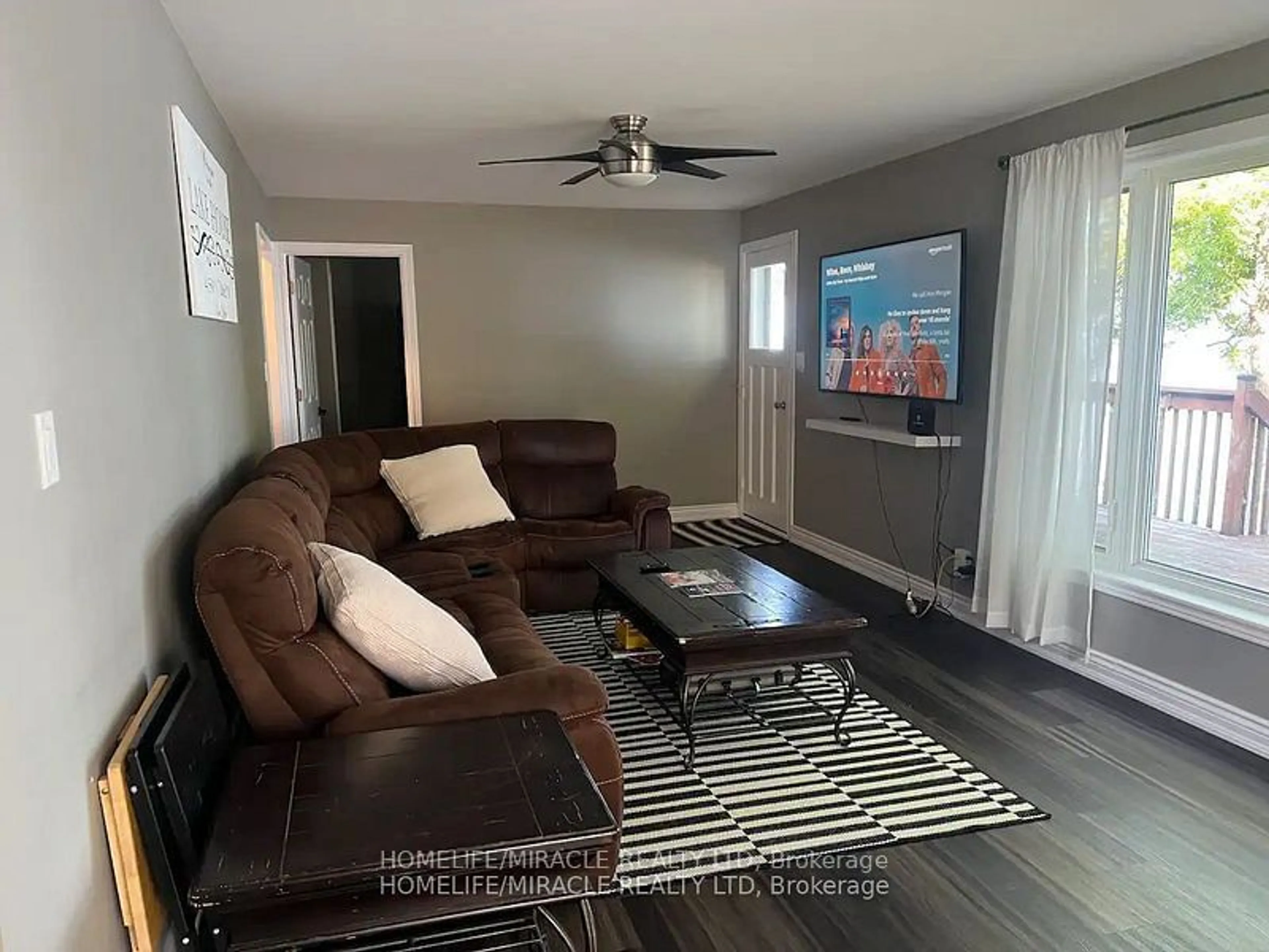 Living room with furniture, wood/laminate floor for 30 Ivey Lane, Peterborough Ontario K9J 6X8