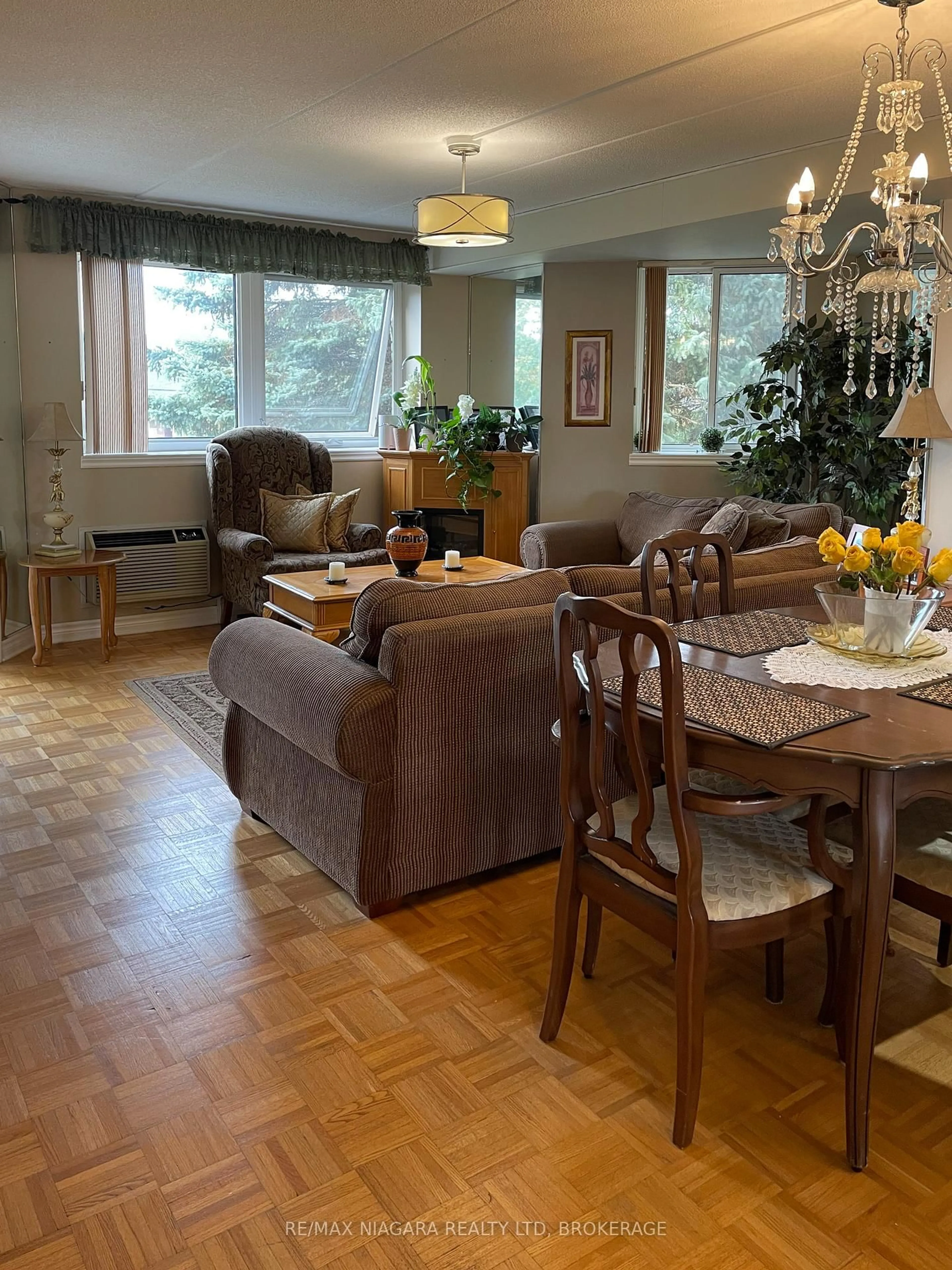 Living room with furniture, wood/laminate floor for 3364 Montrose Rd #201, Niagara Falls Ontario L2E 6S4