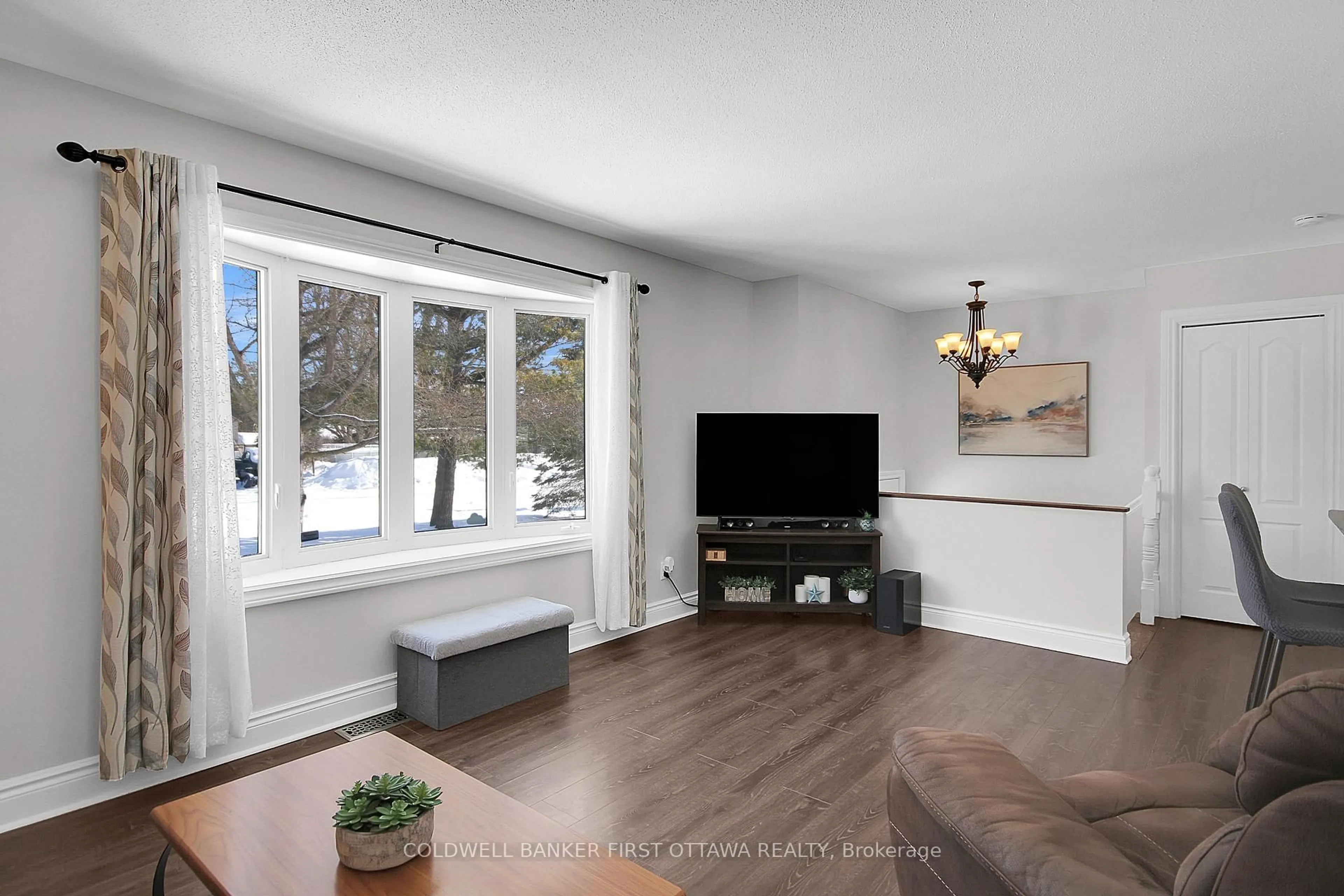 Living room with furniture, wood/laminate floor for 4132 Broadway St, Vernon Ontario K0A 3J0