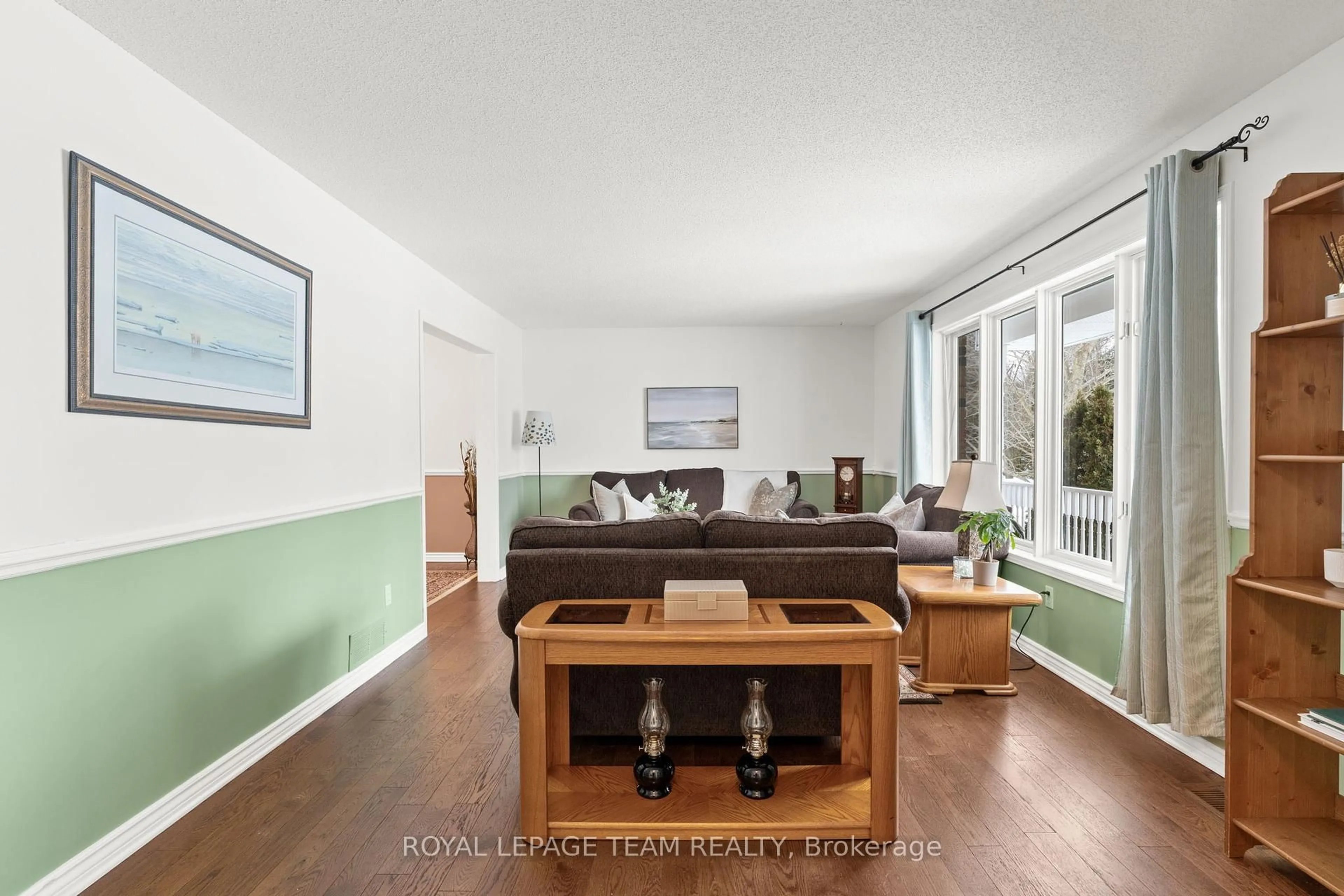 Living room with furniture, wood/laminate floor for 3377 Bramble Lane, Greely - Metcalfe - Osgoode - Vernon and Area Ontario K0A 2W0