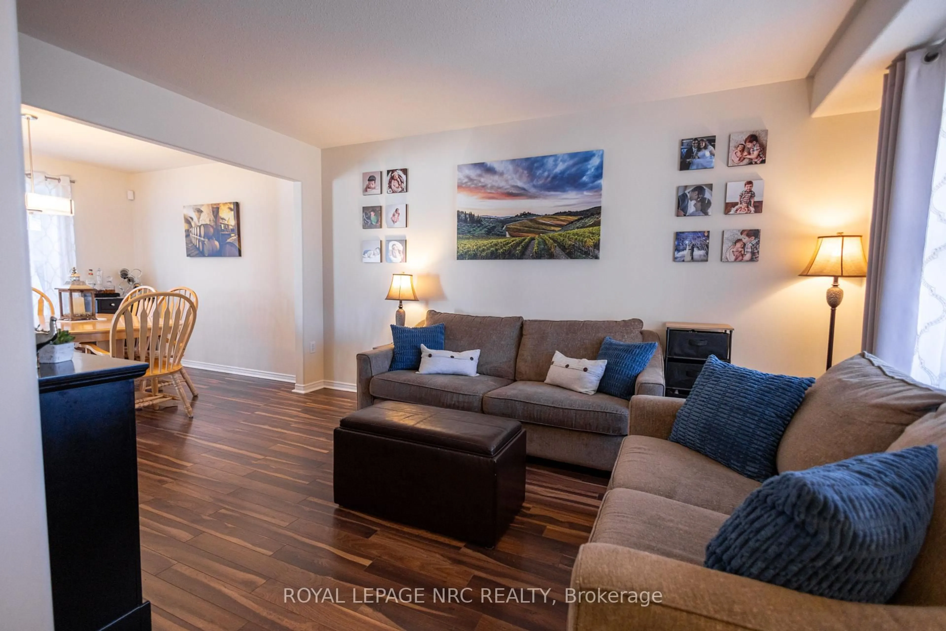 Living room with furniture, wood/laminate floor for 7690 Cortina Cres, Niagara Falls Ontario L2H 3B4