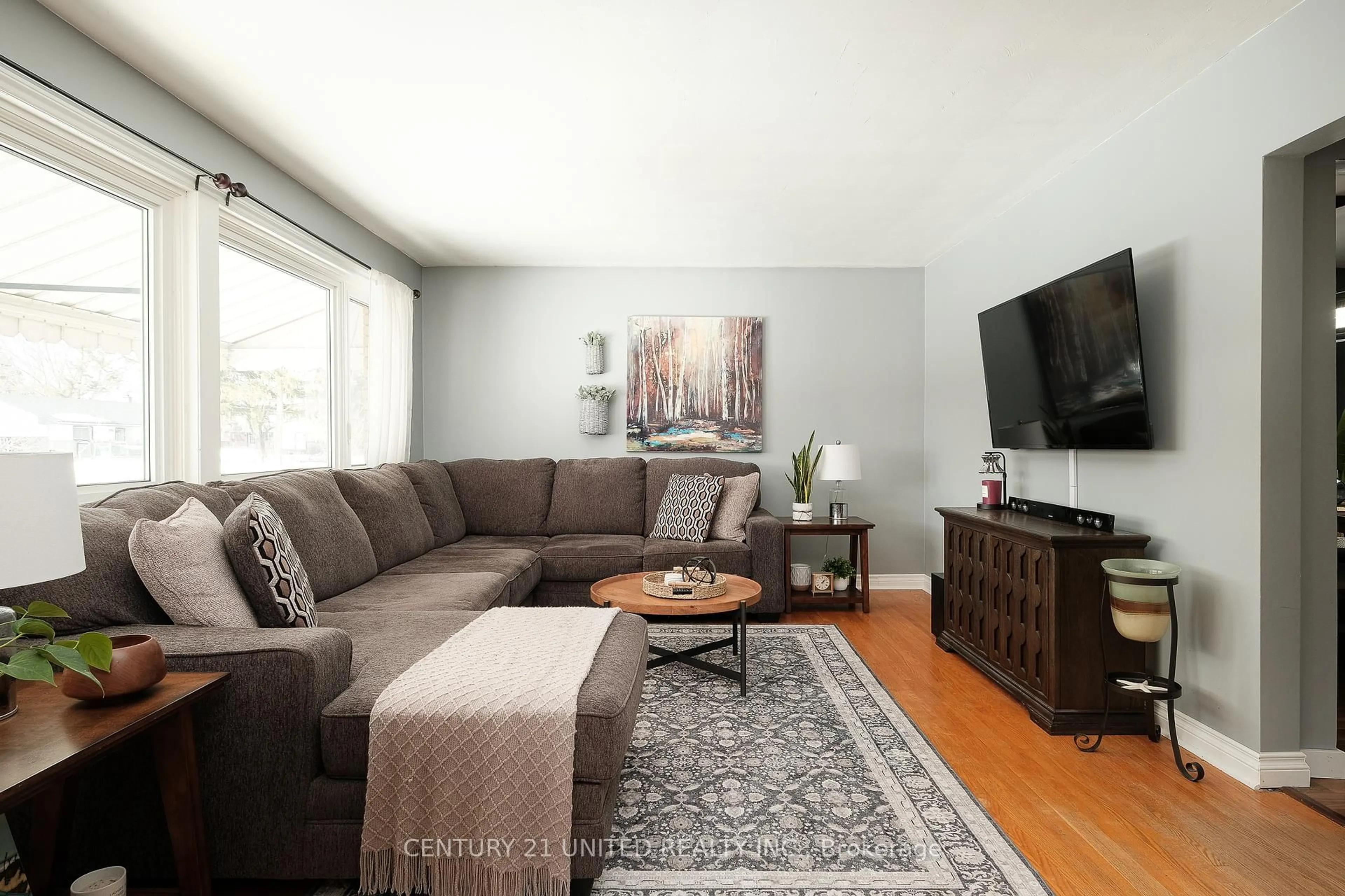 Living room with furniture, wood/laminate floor for 526 Robert Rd, Peterborough South Ontario K9J 5T1