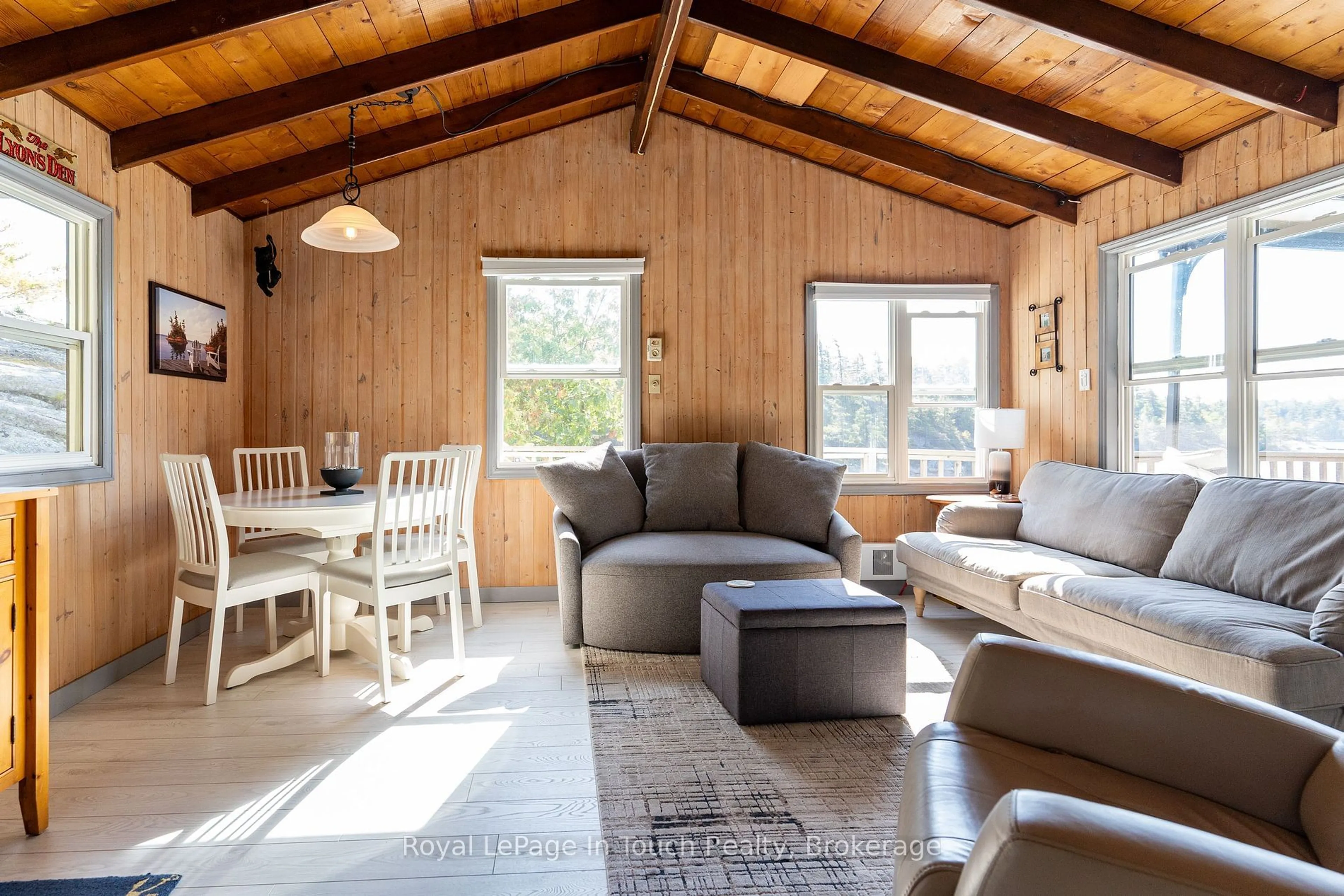 Living room with furniture, wood/laminate floor for 18588 Georgian Bay Shore, Georgian Bay Ontario P0E 1E0