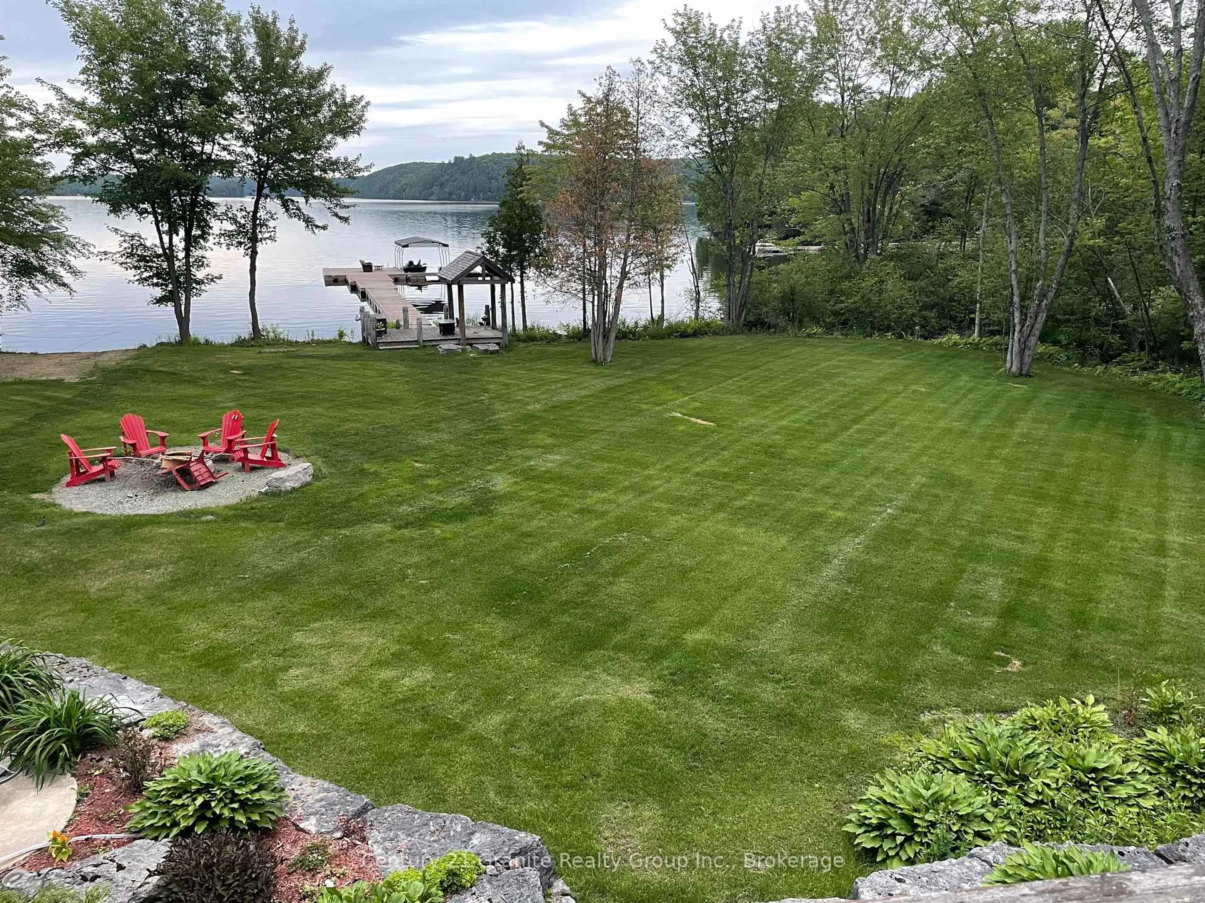 A pic from outside/outdoor area/front of a property/back of a property/a pic from drone, water/lake/river/ocean view for 1047 Bonis Lane, Minden Hills Ontario K0M 2K0