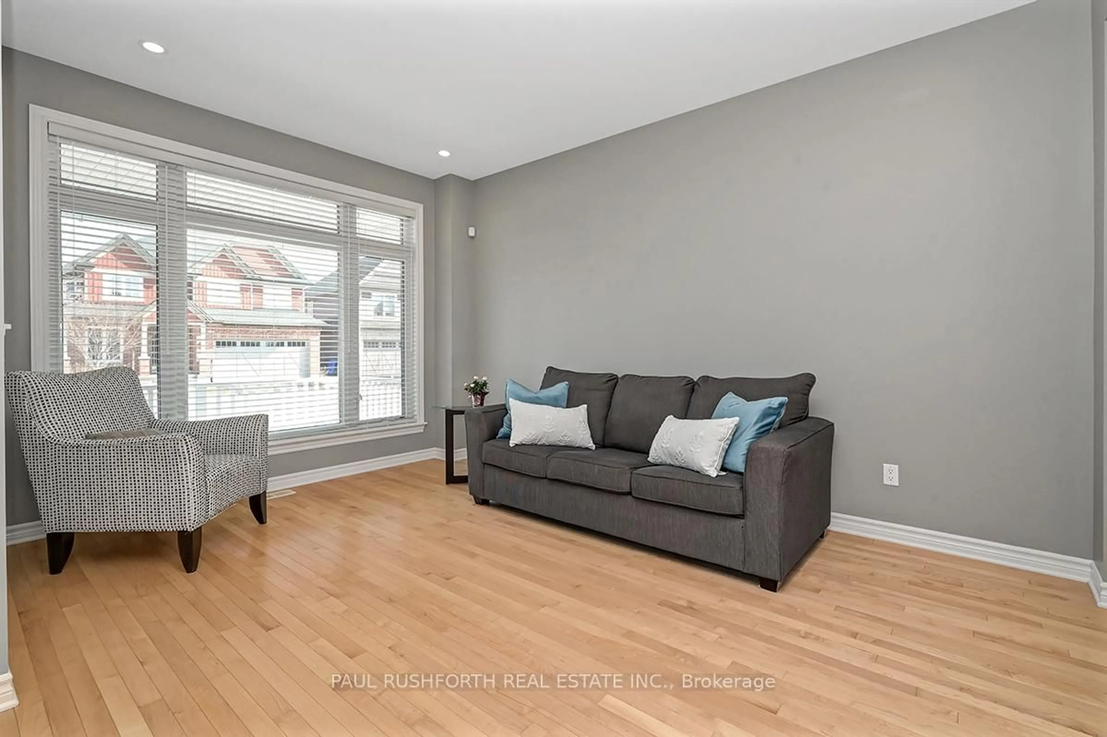 Living room with furniture, wood/laminate floor for 717 Willowmere Way, Ottawa Ontario K1T 0L6