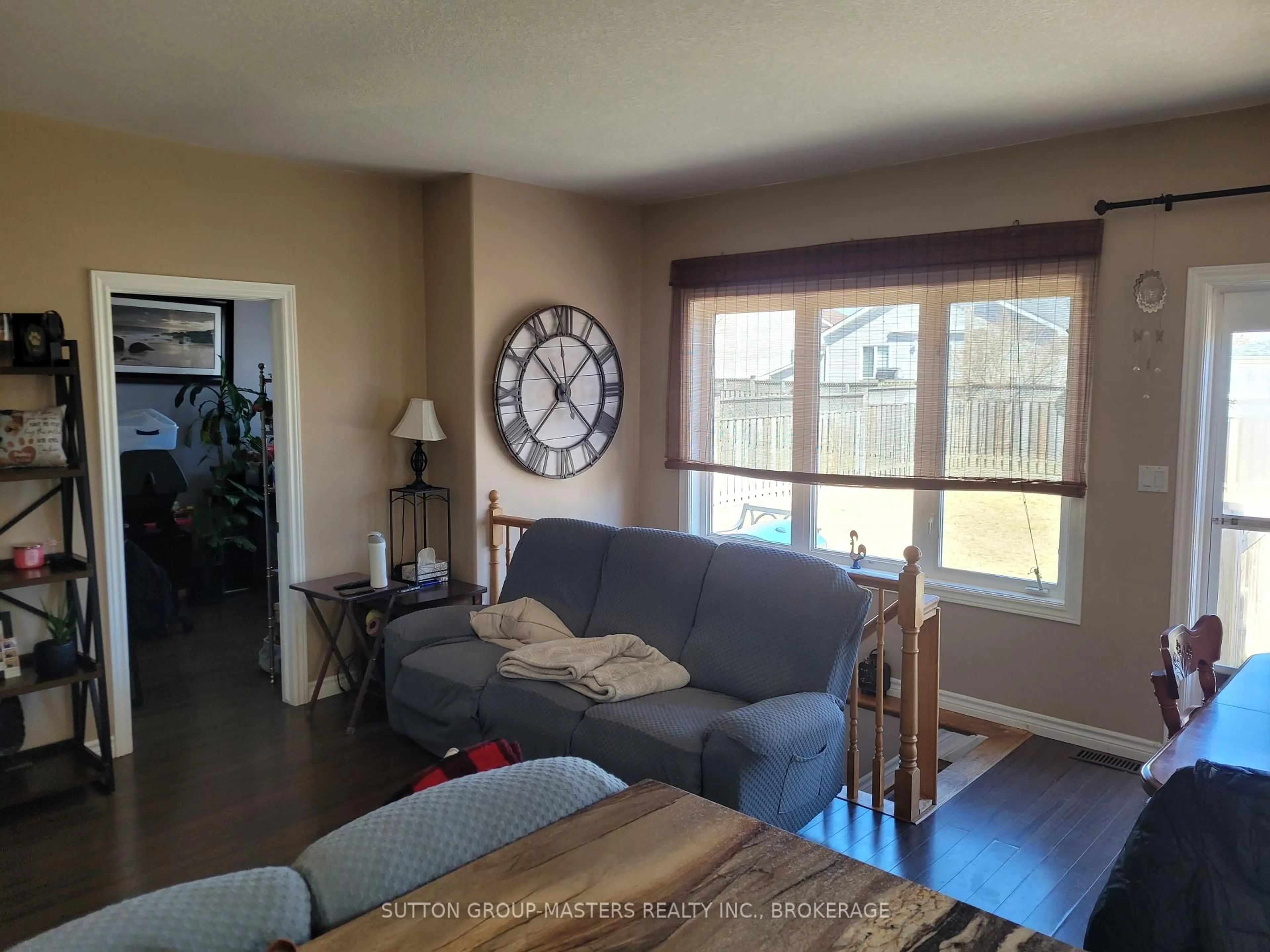 Living room with furniture, wood/laminate floor for 129 Macdougall Dr, Loyalist Ontario K7N 0A2