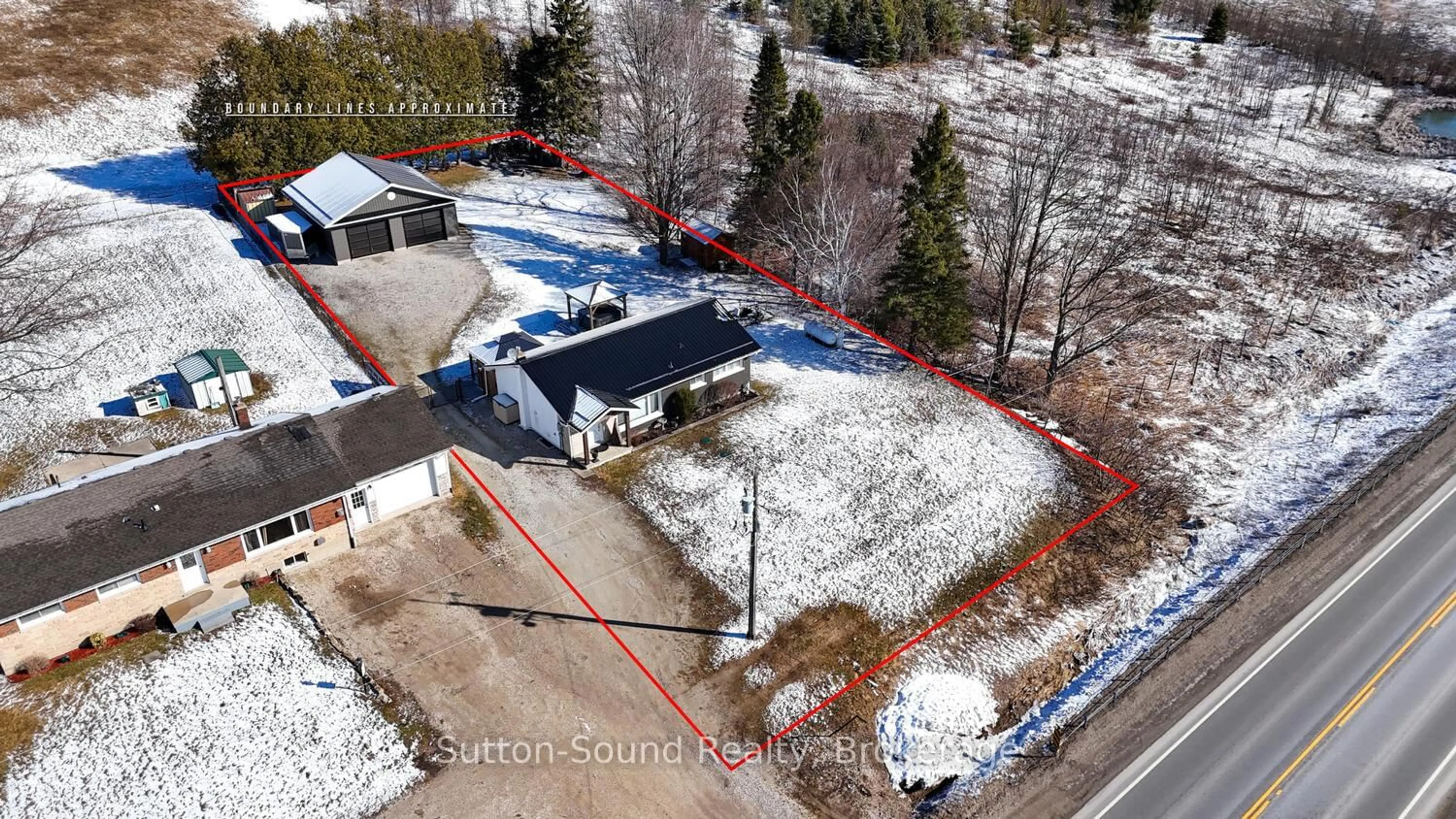 A pic from outside/outdoor area/front of a property/back of a property/a pic from drone, street for 202093 21 Highway, Georgian Bluffs Ontario N4K 5N7