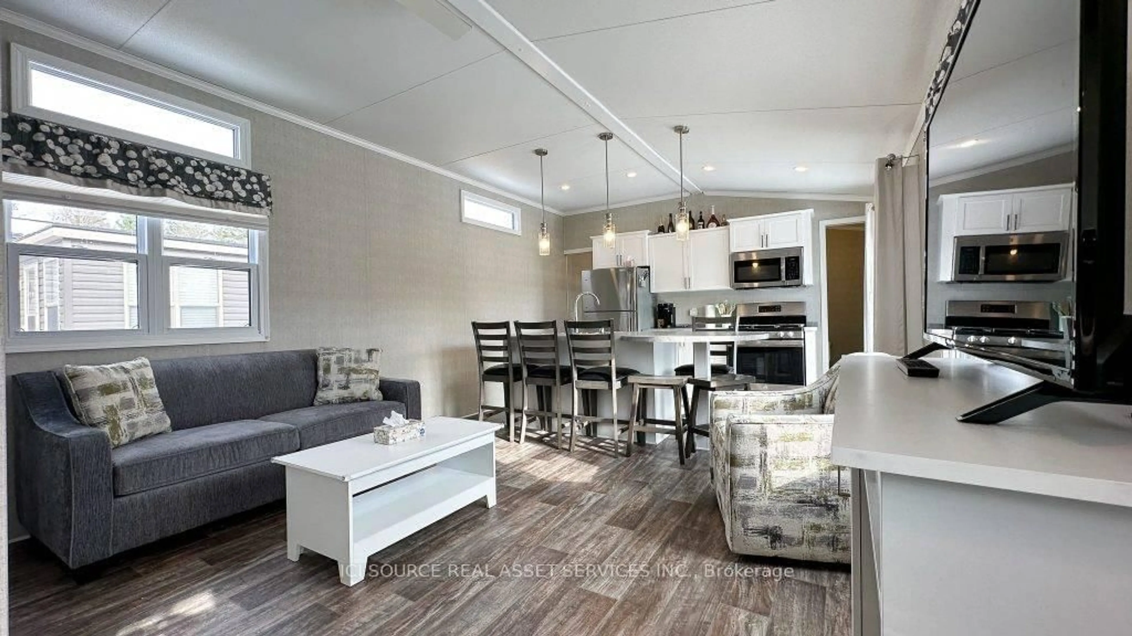 Open concept kitchen, wood/laminate floor for 1047 Bonnie Lake Camp Rd #HERON, Bracebridge Ontario P1L 1W9