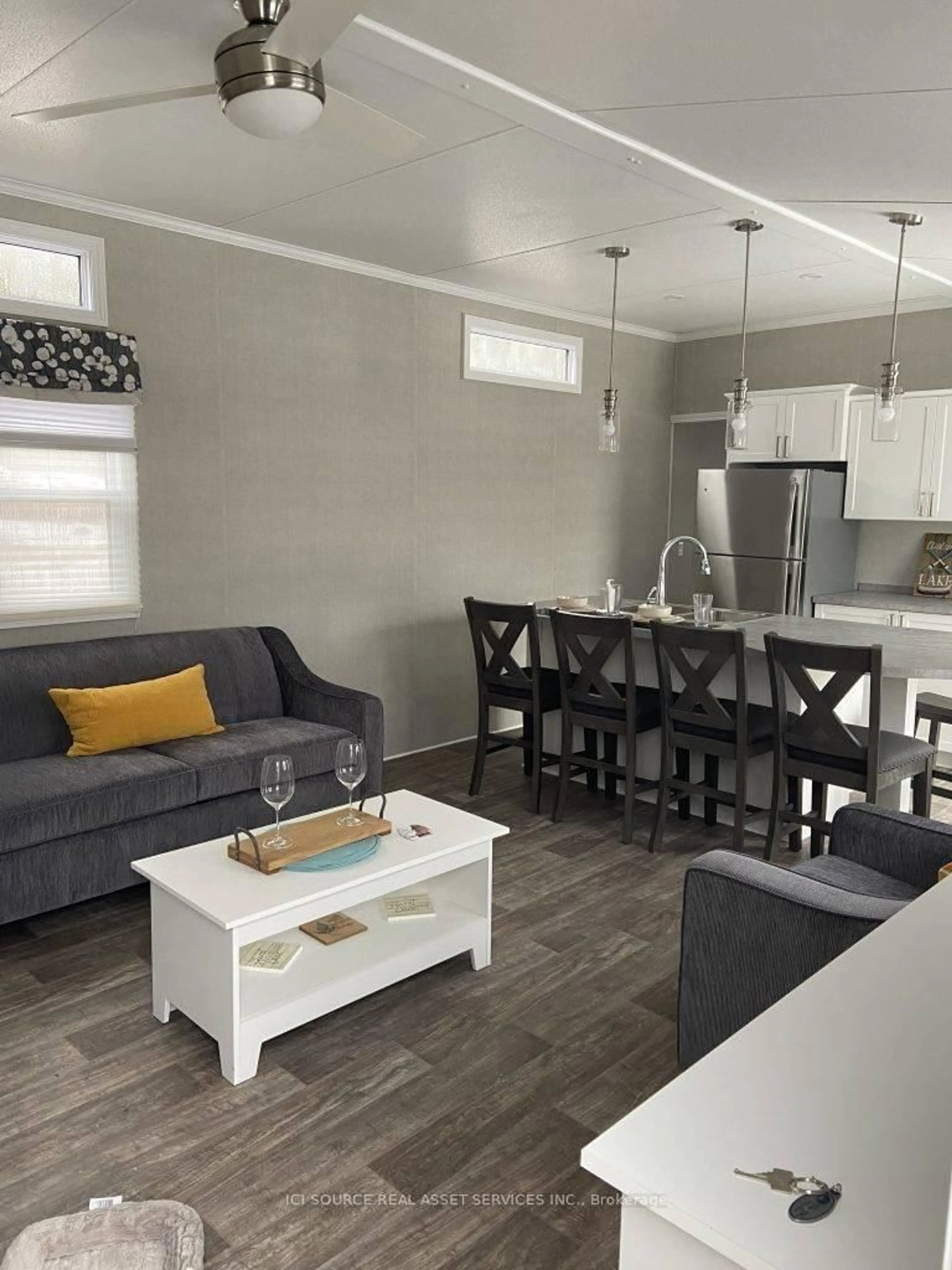 Living room with furniture, wood/laminate floor for 1047 Bonnie Lake Camp Rd #HERON, Bracebridge Ontario P1L 1W9