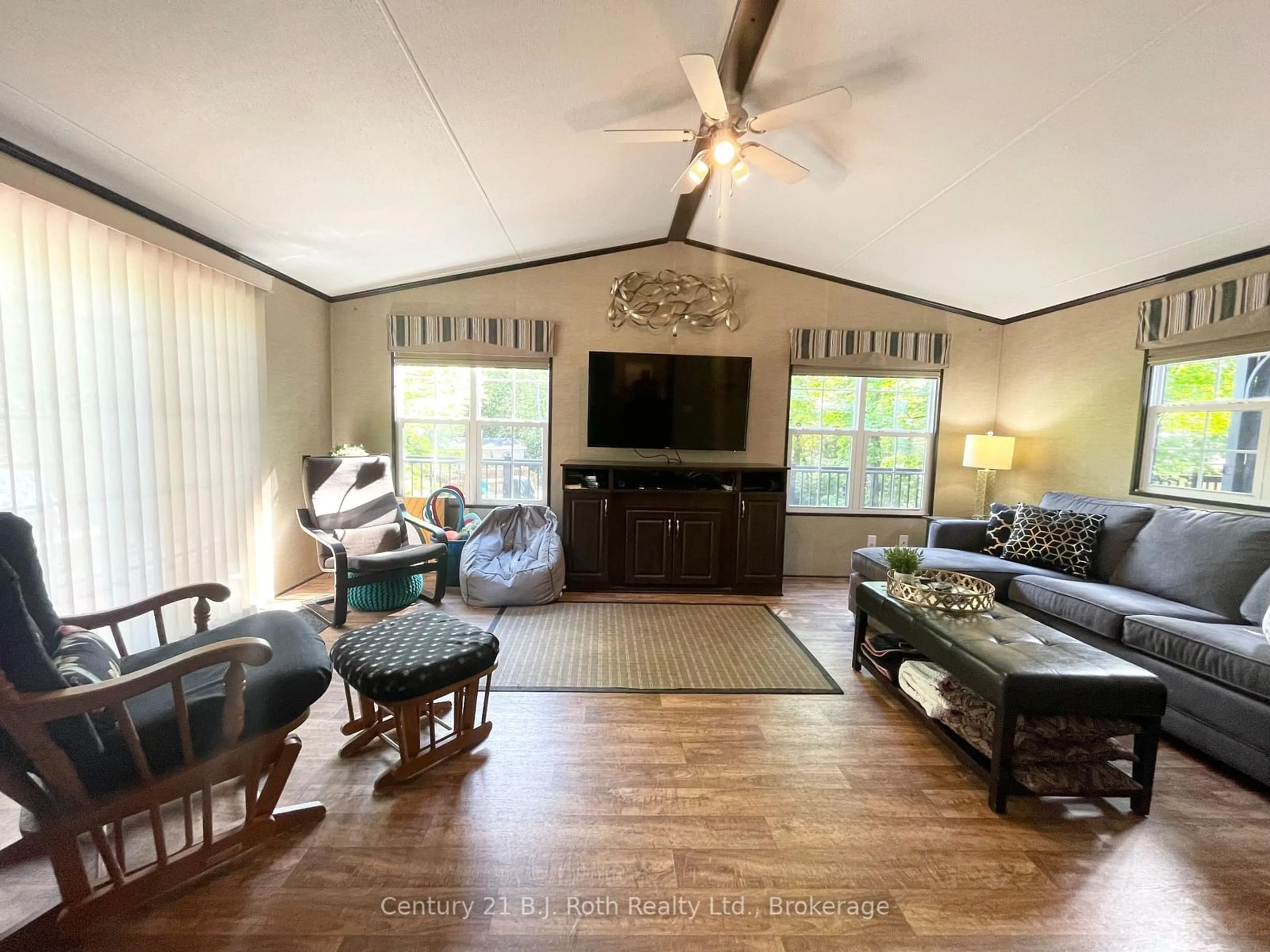 Living room with furniture, wood/laminate floor for 1047 Bonnie Lake Camp Rd #439 Springwater, Bracebridge Ontario P1L 1W9