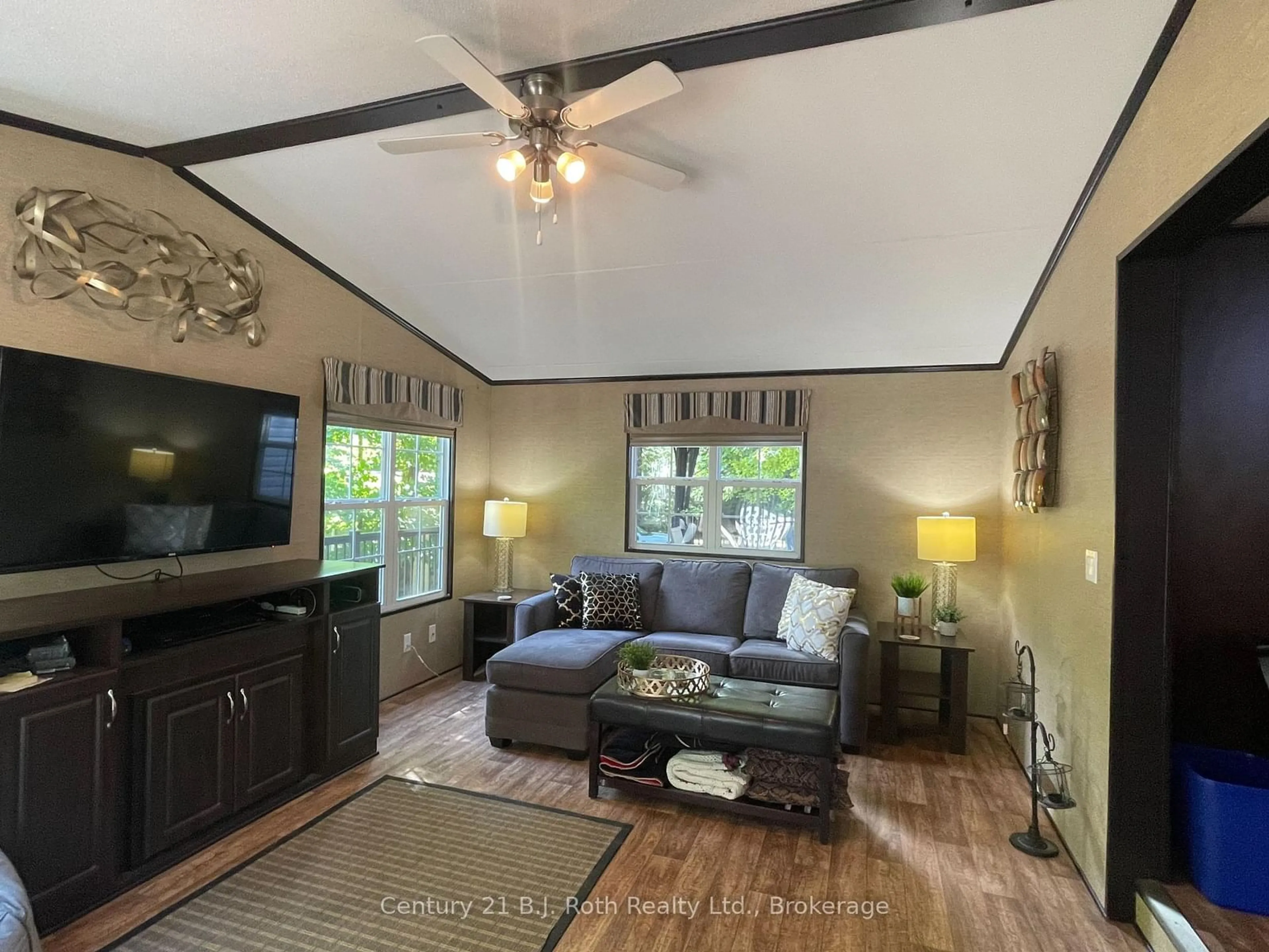 Living room with furniture, wood/laminate floor for 1047 Bonnie Lake Camp Rd #439 Springwater, Bracebridge Ontario P1L 1W9