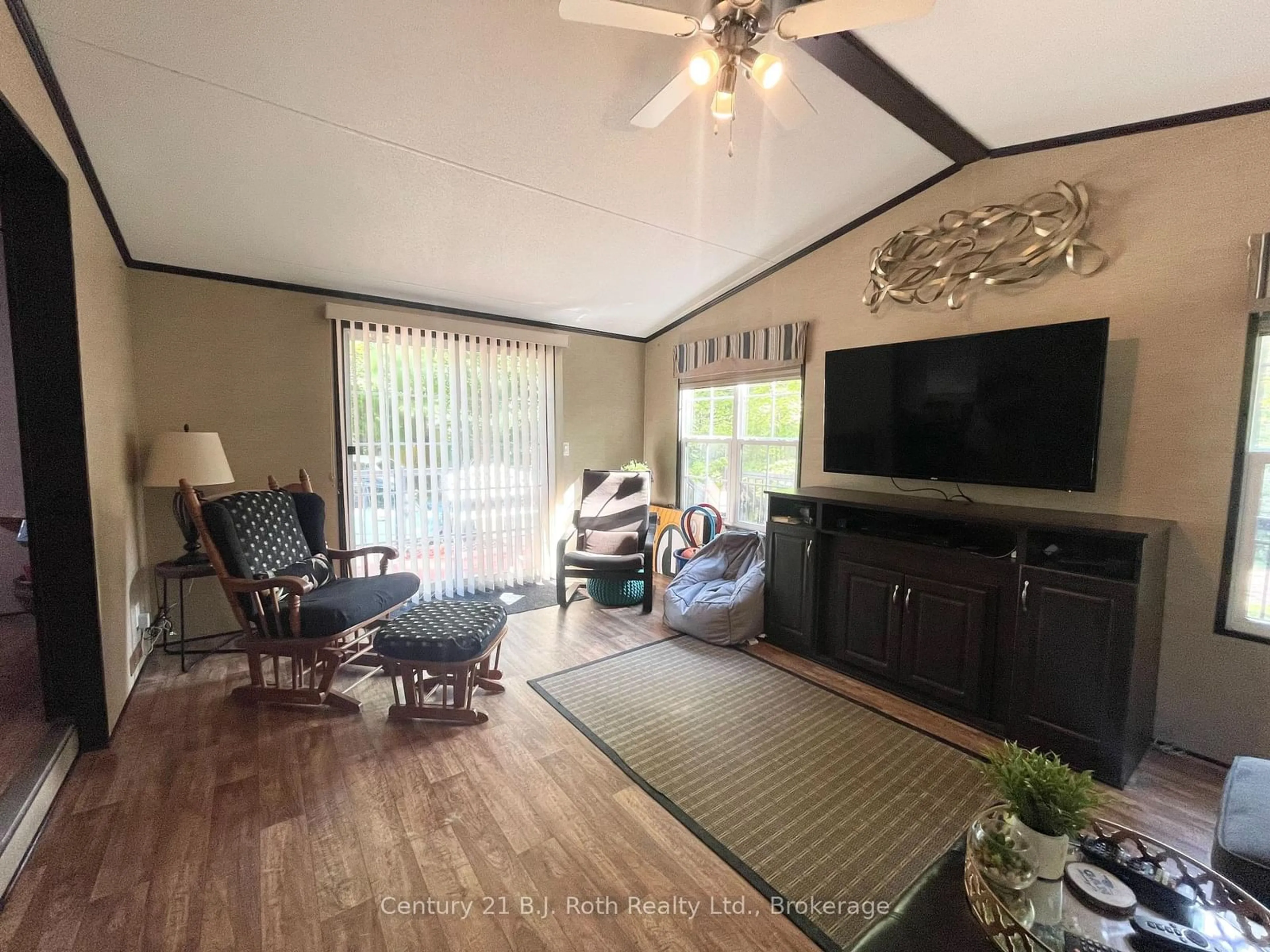 Living room with furniture, wood/laminate floor for 1047 Bonnie Lake Camp Rd #439 Springwater, Bracebridge Ontario P1L 1W9