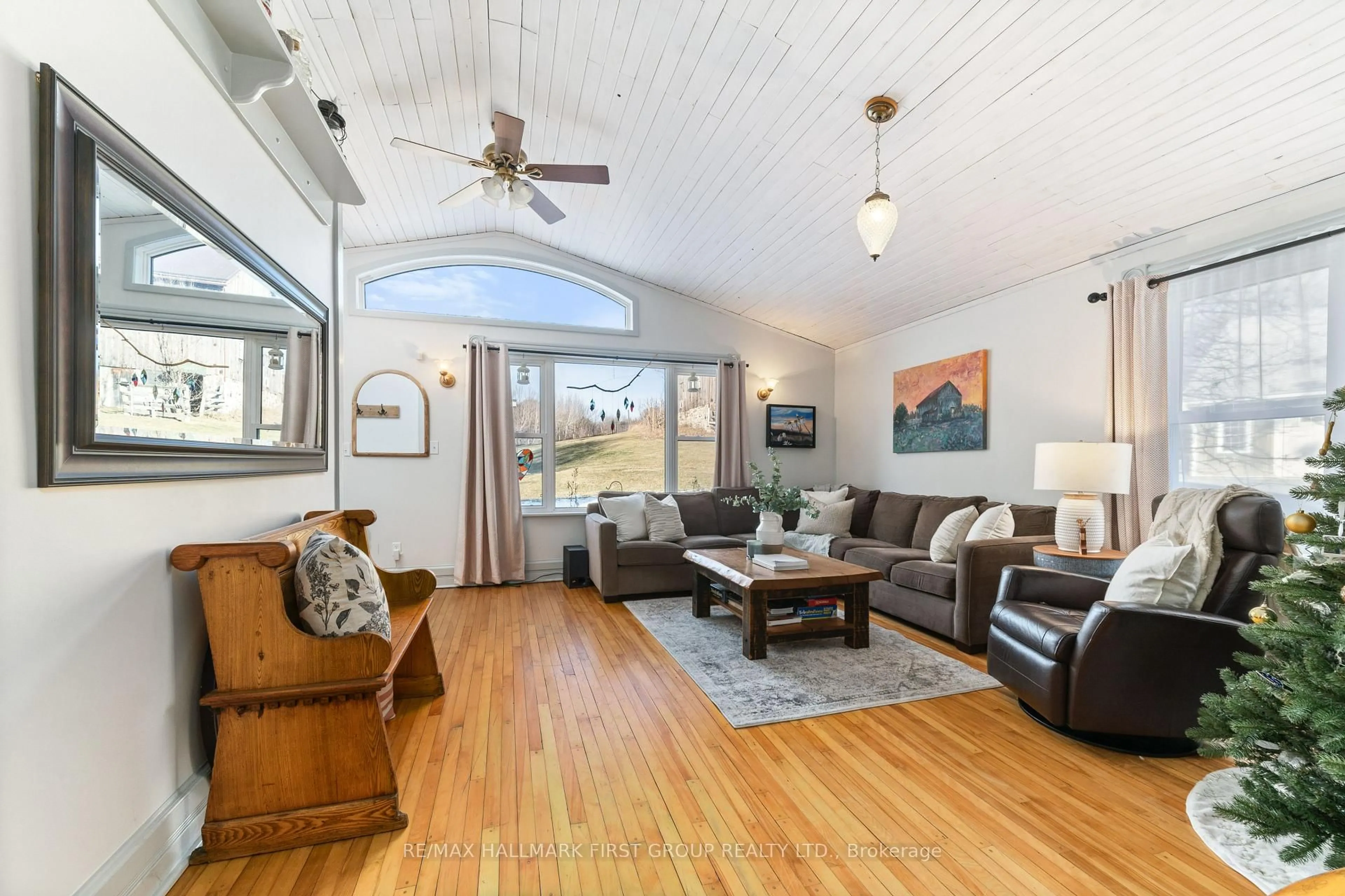 Living room with furniture, wood/laminate floor for 16882 Telephone Rd, Ingleside Ontario K8V 5P4