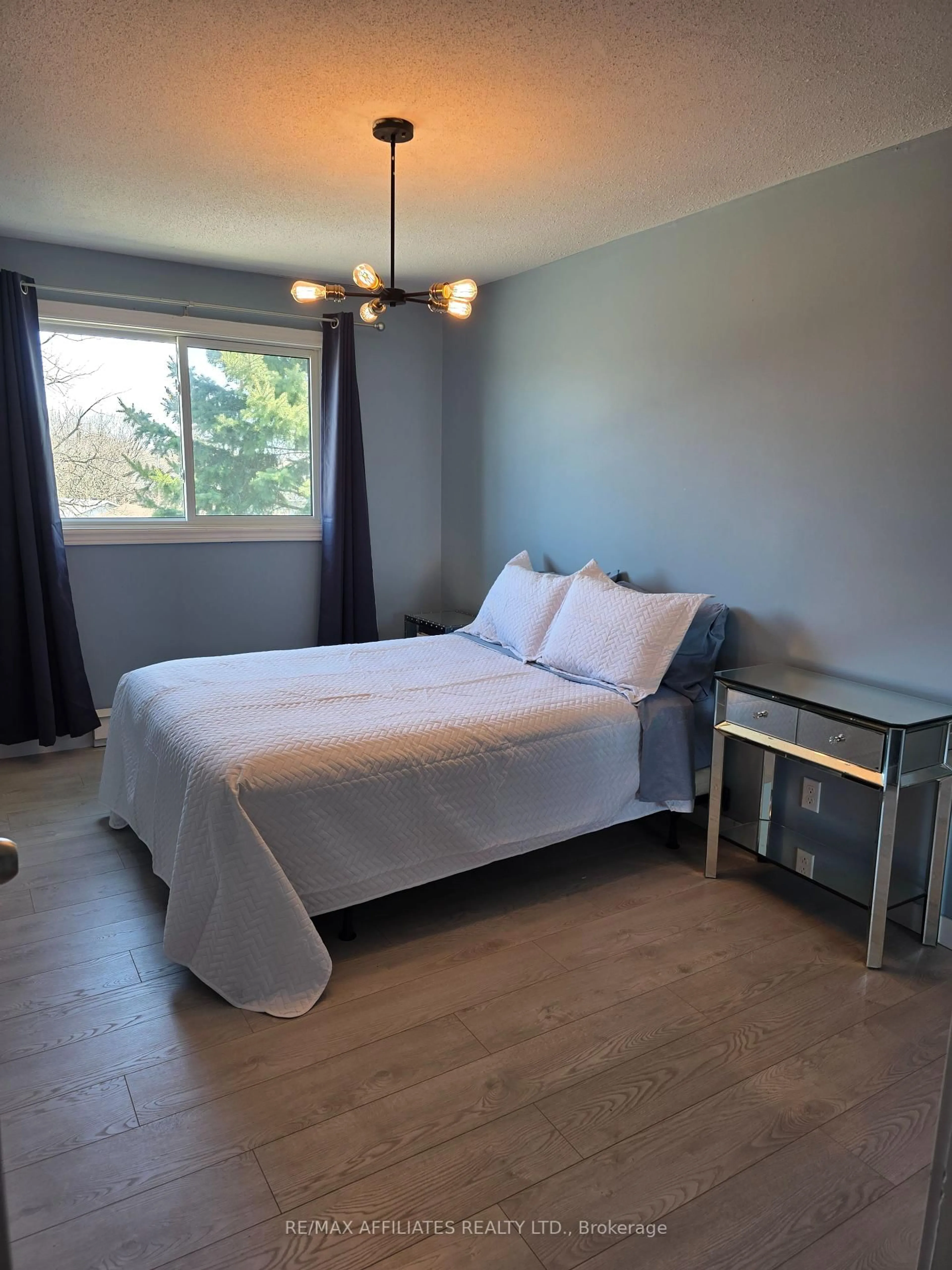 Bedroom with bed, wood/laminate floor for 26 Pearl St #301, Smiths Falls Ontario K7A 5B5