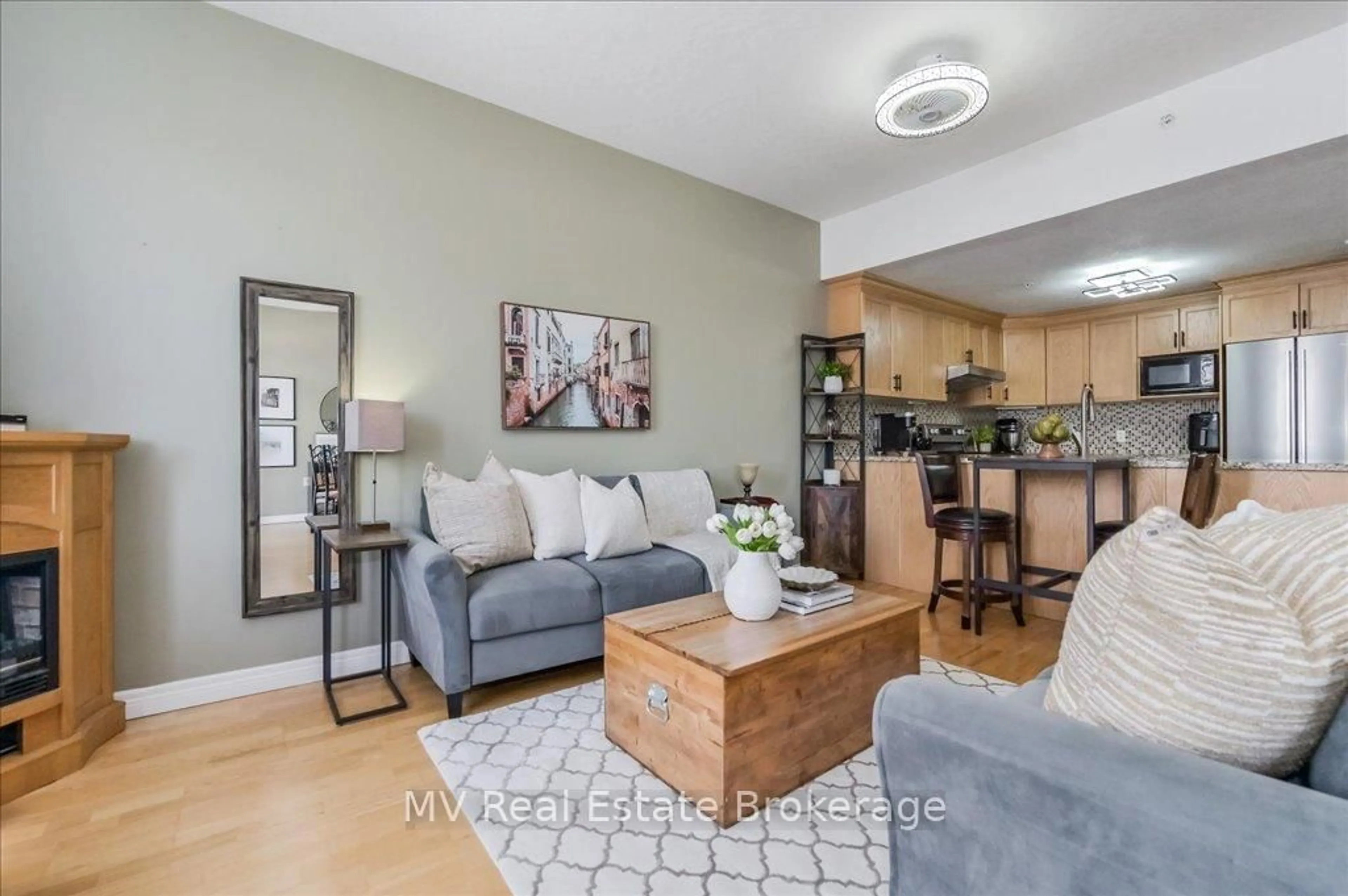 Living room with furniture, wood/laminate floor for 20 Station Sq #209, Centre Wellington Ontario N0B 1S0