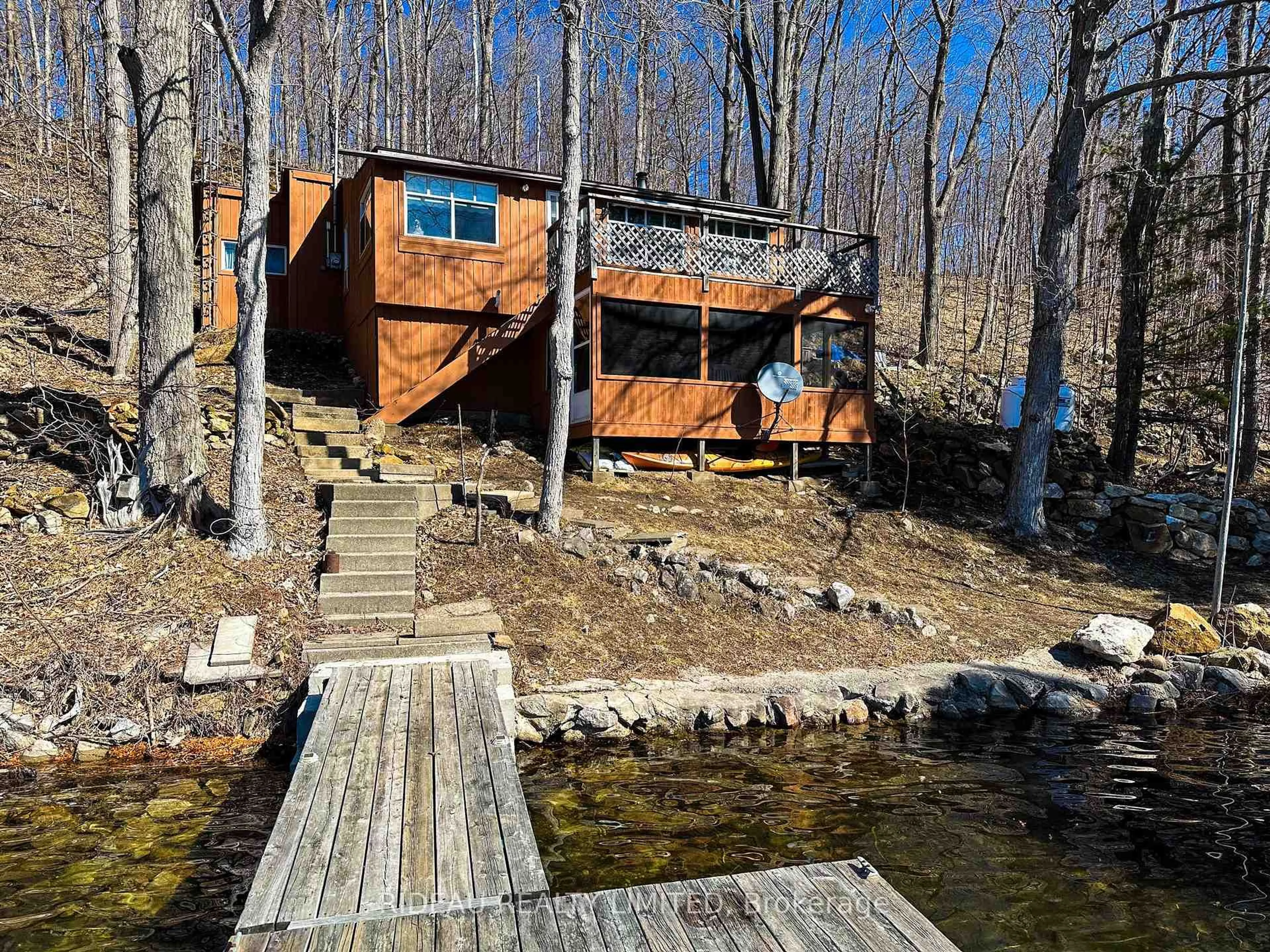 A pic from outside/outdoor area/front of a property/back of a property/a pic from drone, water/lake/river/ocean view for 72 Dragonfly Lane, Westport Ontario K0G 1X0